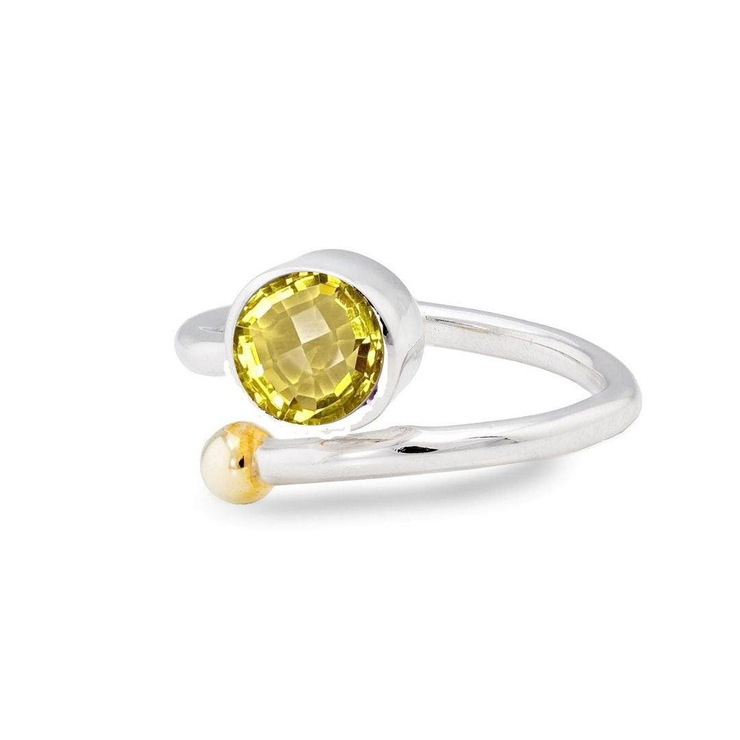The Adjustable Honeysuckle Ring by Gallardo & Blaine Designs features an open design in silver gold with a round yellow gemstone and a small bead, elegantly curving around the finger. This comfortable, adjustable ring captures nature's charm in every deta