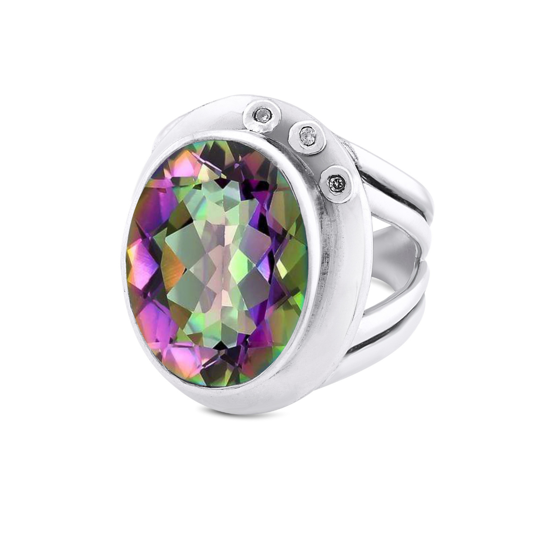 The Eyetelia Ring by Gallardo & Blaine Designs is a sterling silver cocktail ring showcasing an oval-cut multicolored gemstone in green, purple, and yellow, accented with three round white stones on the band.