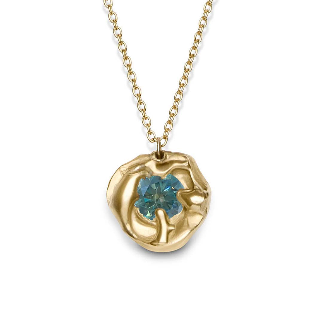 The Molten Necklace with Moissanite by Madeleine Sculptural Jewellery features an organic, textured gold pendant set with a round moissanite gemstone, highlighting sustainable craftsmanship on a simple gold chain.