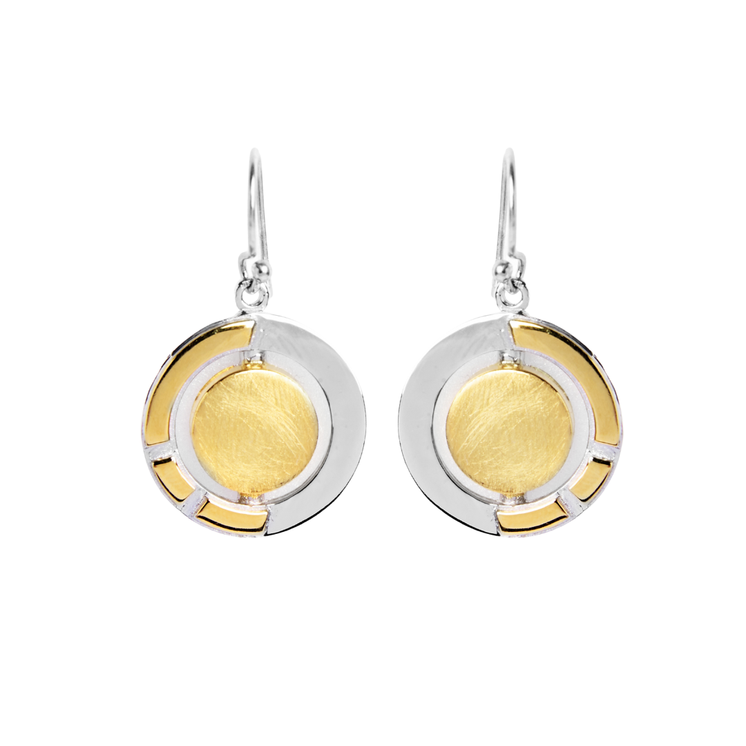 The Urú Dangle Earrings by Gallardo & Blaine Designs feature a round, gold-toned center, silver outer ring with gold accents, and sterling silver hooks—an elegant nod to timeless Irish heritage jewelry.
