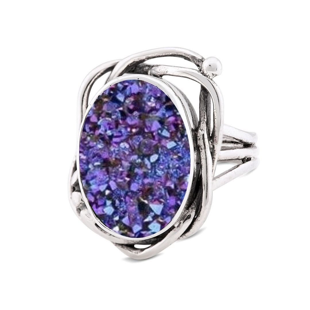 The Gallardo & Blaine Designs Whirlpool Ring features an intricate, swirling silver band and a large oval centerpiece set with sparkling textured purple gemstones.