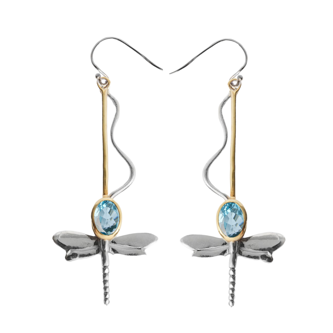 The Willow Earrings in Various Gemstones by Gallardo & Blaine Designs feature silver and gold accents with a blue oval gemstone and easy-to-wear curved hooks—elegant and charming statement pieces.