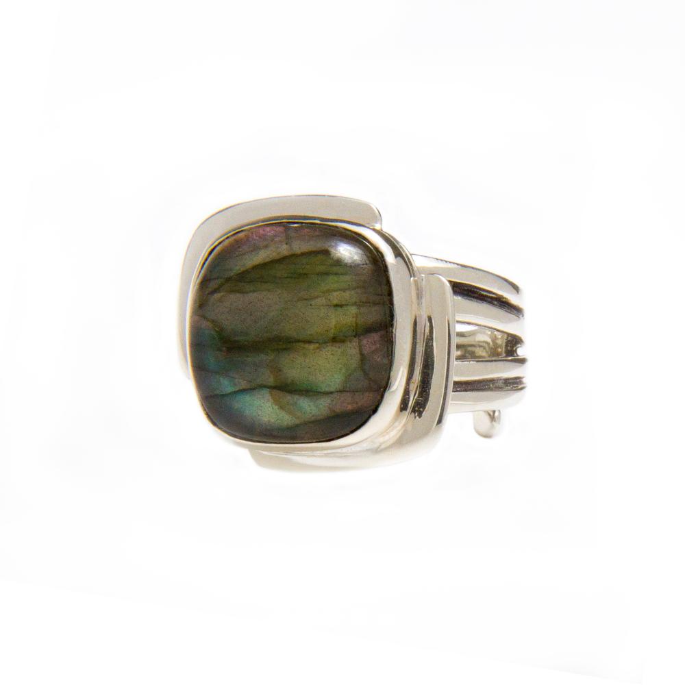 A Gallardo & Blaine Designs Art Deco Ring in Silver Gold & various gemstones featuring a large, polished, multicolored rectangular gemstone with shades of green, blue, and purple. The stone is set in a modern, wide band design with three split shanks on e