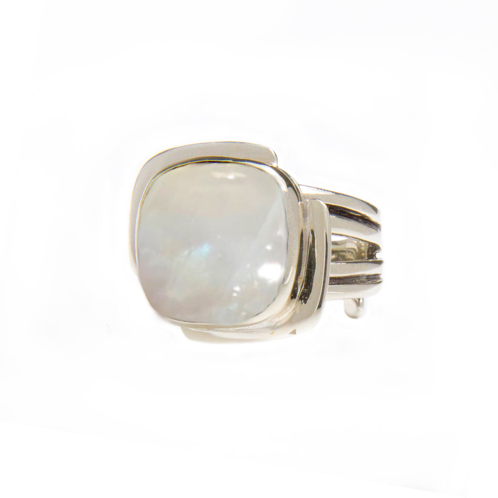 The Gallardo & Blaine Designs Art Deco Ring in Silver Gold & various gemstones features a large, square-cut white gemstone in the center. The band of the ring is composed of several parallel strips of silver, giving it a modern and sleek design reminiscen