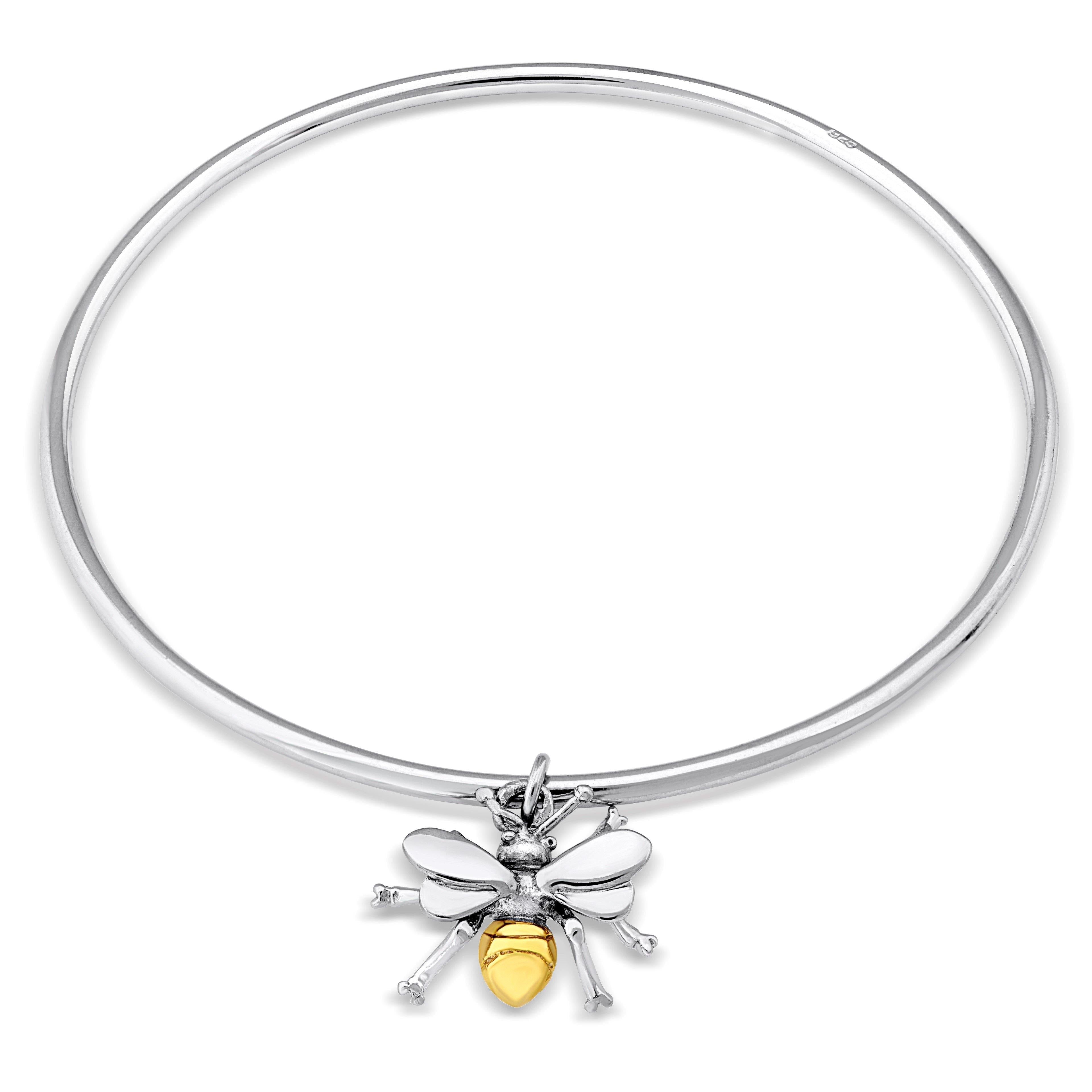 The Wildlife Bee Bangle Silver & Gold original by Watermelon Tropical features a detailed bee charm with silver wings and a gold-toned body, elegantly blending symbolic design with silver and gold jewelry accents.