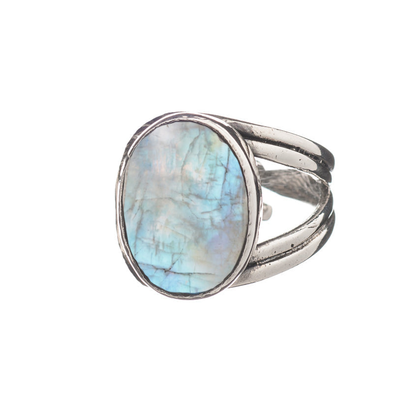 A chunky statement ring crafted from sterling silver, featuring a large, oval-shaped, iridescent gemstone with shades of blue and green. The band is split into three sections on either side of the stone, giving a unique and elegant design. The Dewberry Ri