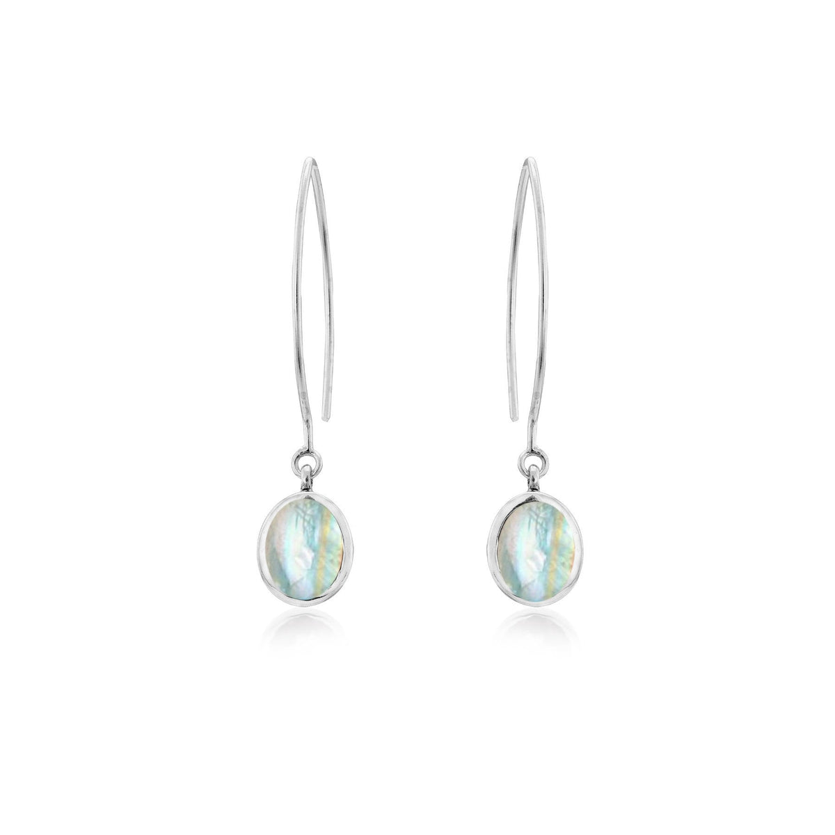The Dew Drop Earrings in various gemstones by Gallardo & Blaine Designs feature oval-shaped, iridescent gemstones. The sterling silver earrings have a sleek and elegant design with a thin hook and a single hanging stone that reflects various shades of blu