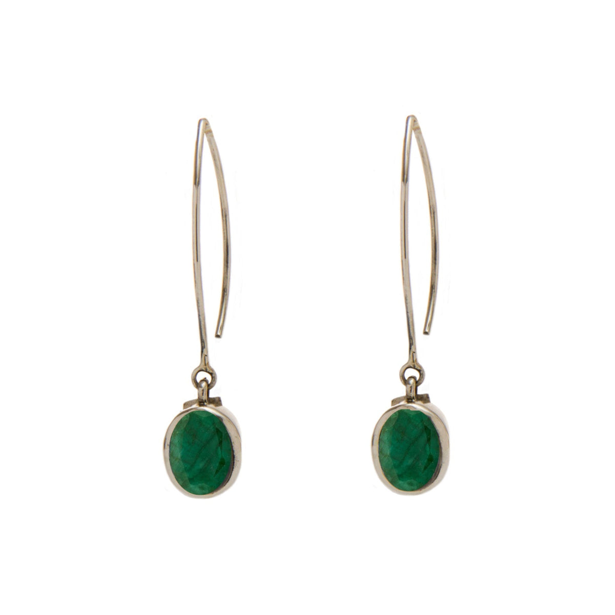 A pair of elegant Dew Drop Earrings in various gemstones by Gallardo & Blaine Designs featuring an elongated metal hook and an oval-shaped green gemstone set in a simple sterling silver frame. The earrings have a minimalist design, with the gemstone dangl