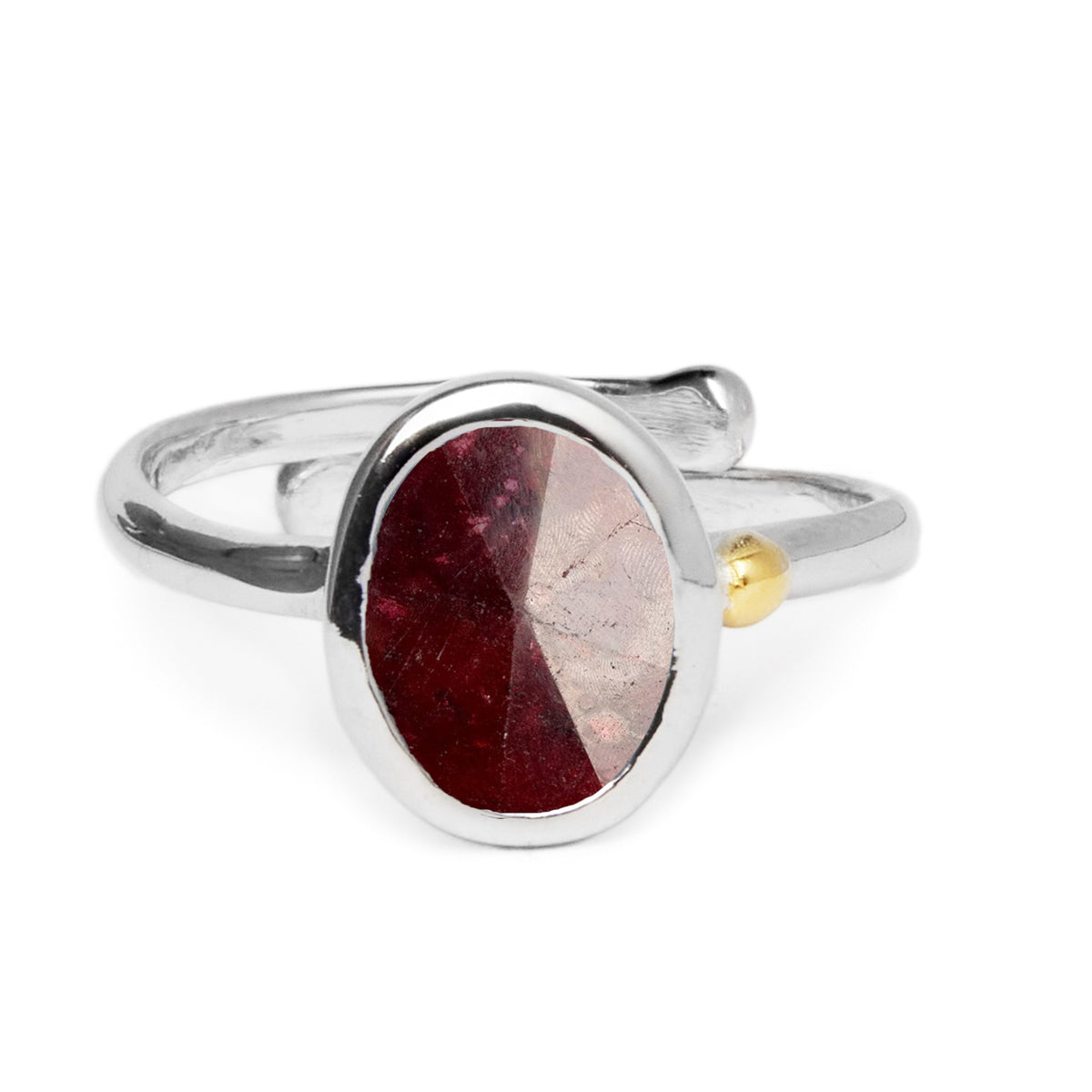 A Gallardo & Blaine Designs Dream Ring in various gemstones featuring a large oval-shaped, deep red gemstone in the center, with a small gold accent on the band. The minimalist design is simple yet elegant, highlighting the gemstone's rich color and polis