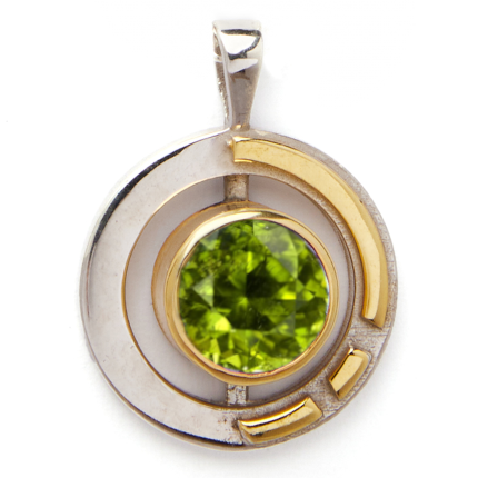 The Elodie Pendant in silver gold & various gemstones by Gallardo & Blaine Designs is a stunning Art Deco piece, featuring a round, sterling silver and gold vermeil design. At its center lies a green, faceted gemstone surrounded by geometric gold accents,