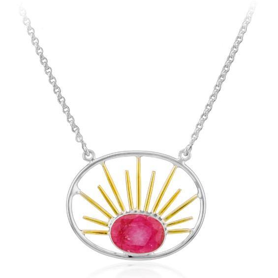 A silver necklace featuring an oval stone pendant with a central pink gemstone. The pendant boasts an open design with gold vermeil rays radiating from the gemstone, creating a stunning sunburst pattern. The simple silver chain complements and enhances th