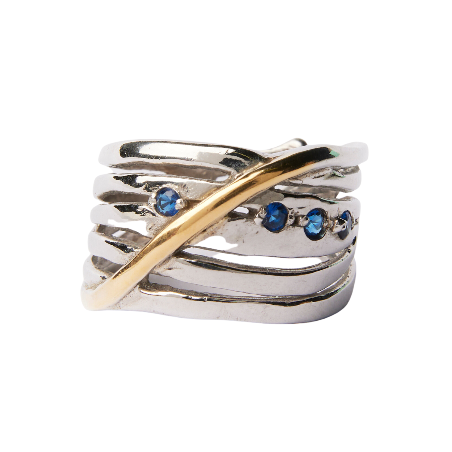A chunky statement ring in sterling silver, featuring seven wavy, overlapping strands with a single gold accent crossing diagonally. This Hidden Gems Ring in Silver & Gold by Gallardo & Blaine Designs is adorned with three small blue gemstones set in one