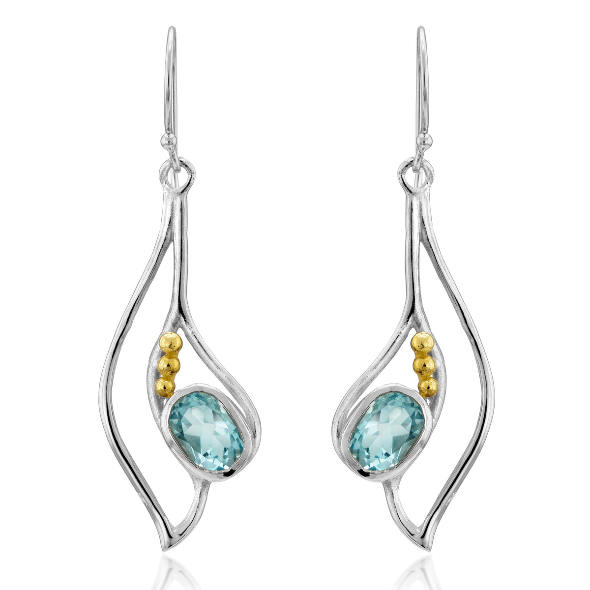 The Iris Earrings in various gemstones are elegant silver drop earrings featuring oval blue gemstones set in the center, each adorned with three small gold beads on the sides. These gemstone earrings hang from delicate hooks, showcasing a modern, fluid de