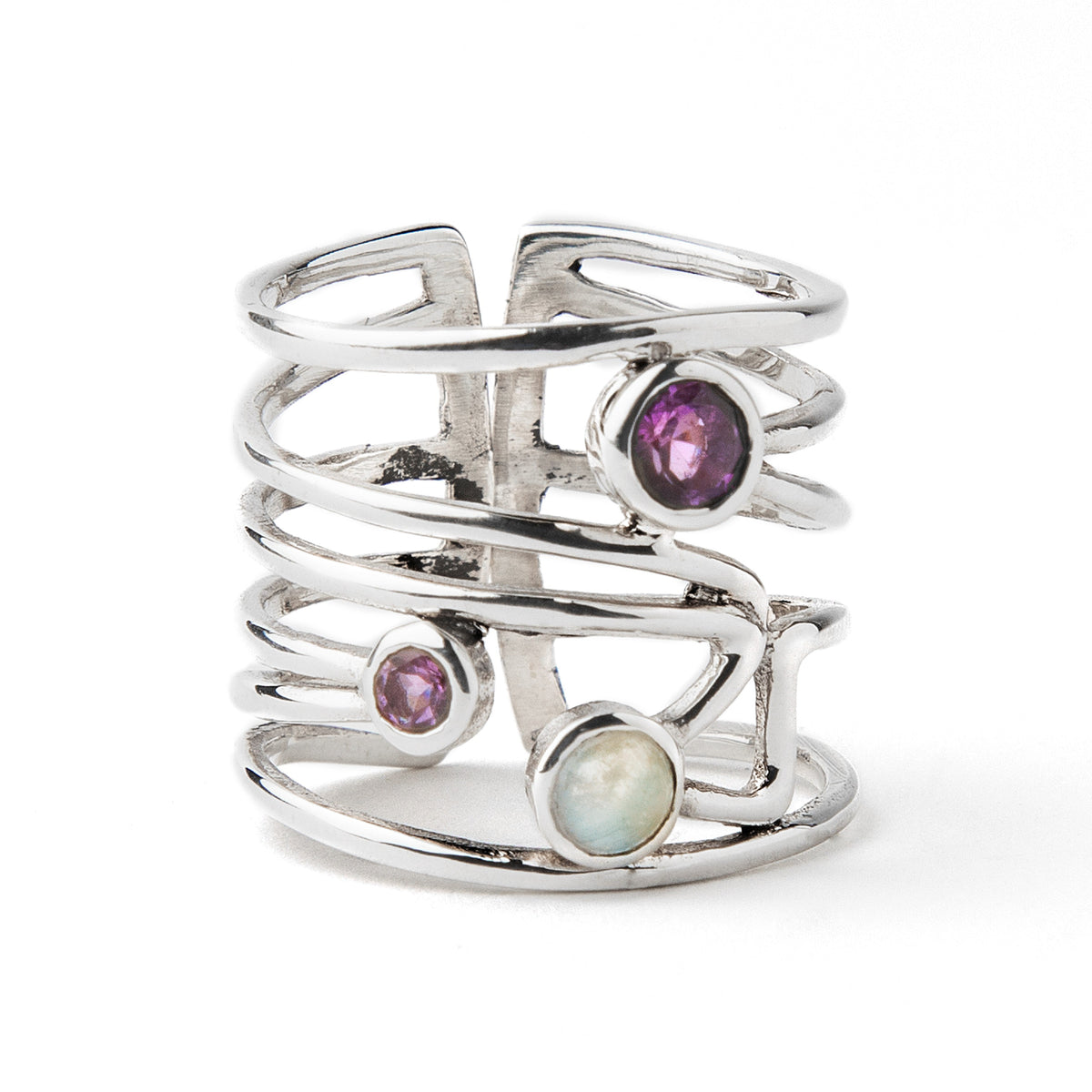 A Lattice Ring in various gemstones by Gallardo & Blaine Designs in silver featuring an open, multi-band design with three gemstones: a purple amethyst, a smaller purple stone, and a round opal, all set in a vertical arrangement. The ring's bands are inte