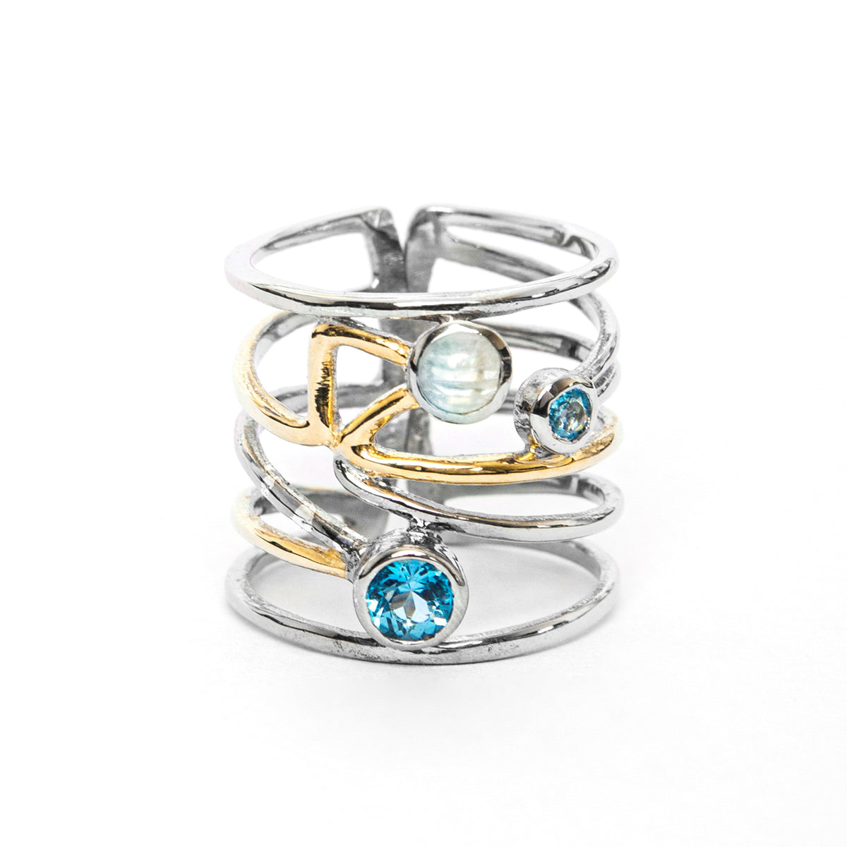 A Lattice Ring in various gemstones featuring an intricate multi-band design with gold accents, this piece showcases a contemporary design. Adorned with three gemstones: a blue gemstone at the base, a smaller blue gemstone on one side, and a round opalesc