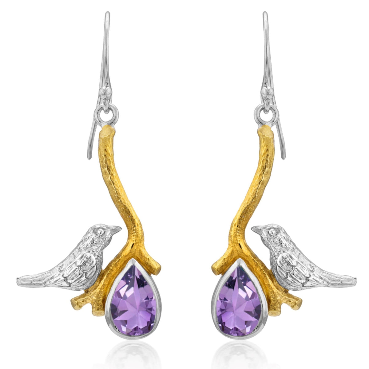A pair of elegant Lovebird Earrings in various gemstones from Gallardo & Blaine Designs featuring a design with silver birds perched on gold branches. Each branch holds a teardrop-shaped purple gemstone, adding a touch of color and sophistication to these