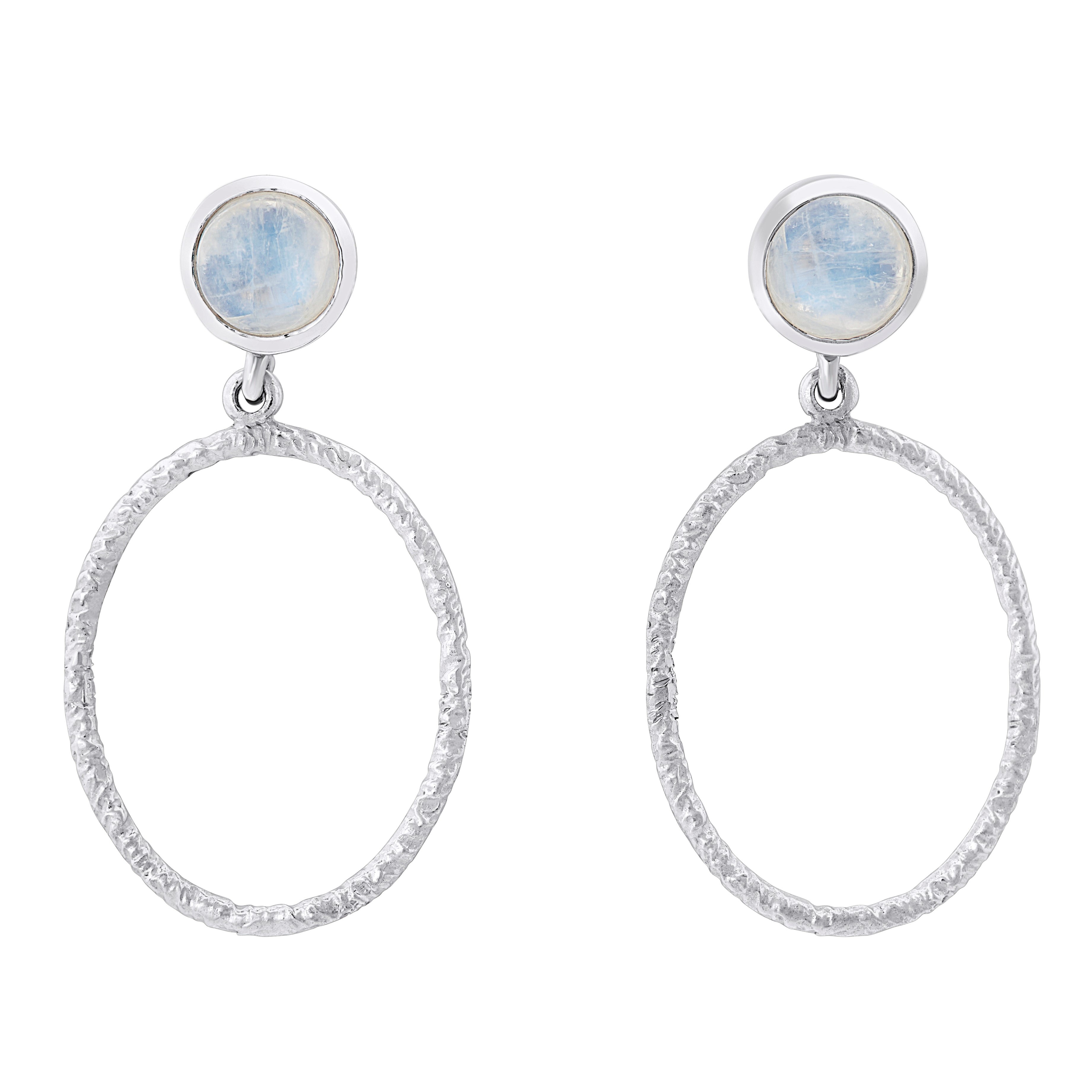 A pair of elegant Lunar Earrings in various gemstones by Gallardo & Blaine Designs featuring circular, textured hoops dangling from small round blue stone studs. The stones at the top have a soft, translucent appearance, adding a subtle touch of color to