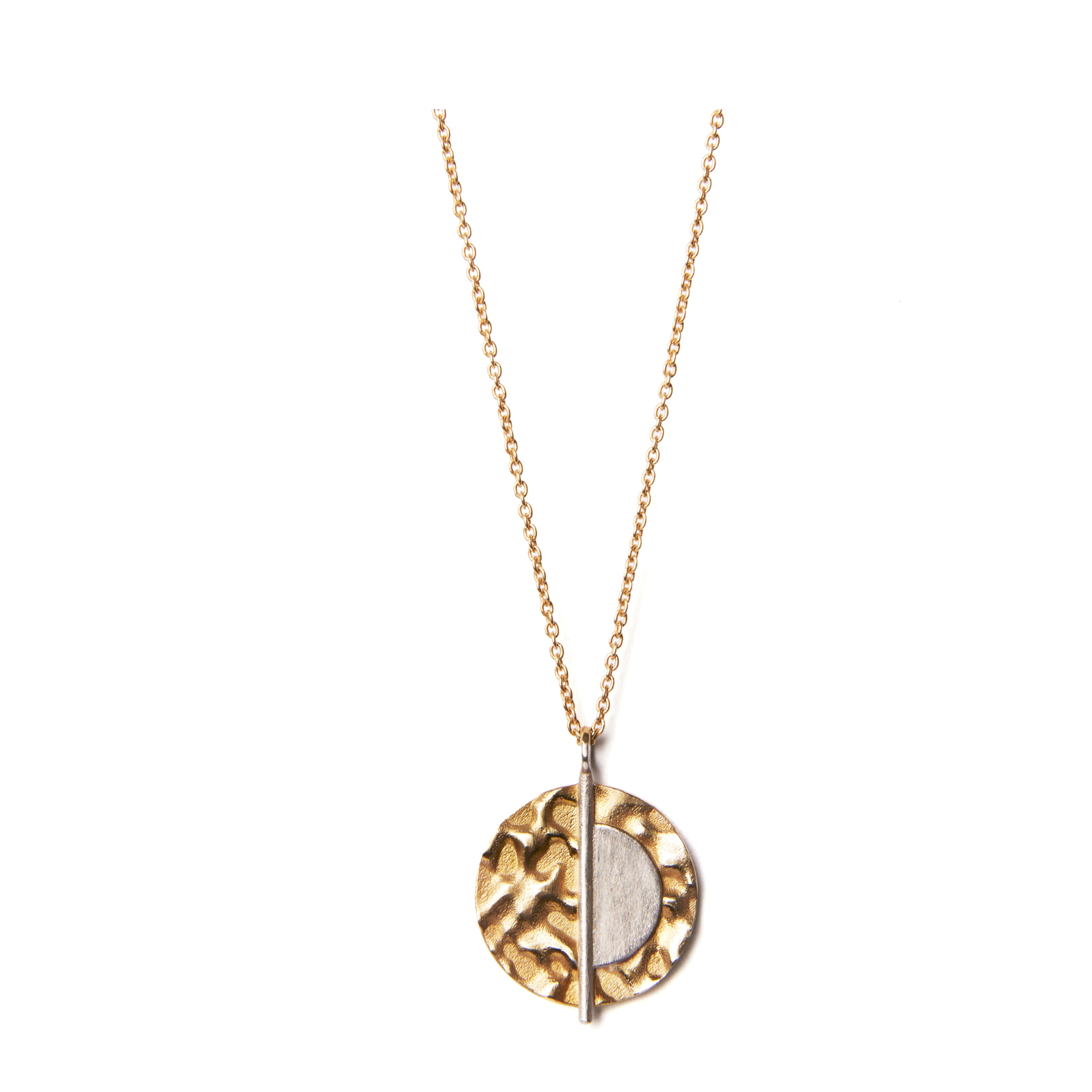 The Lunar Eclipse Pendant & Chain by Gallardo & Blaine Designs is a gold vermeil necklace featuring a textured round pendant on a delicate chain. The pendant design is split into two sections: one half is smooth sterling silver, while the other half boast
