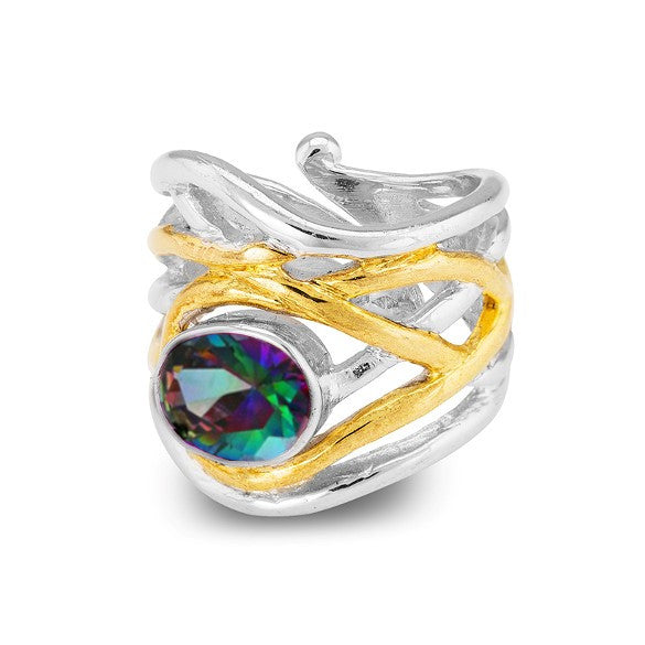 A silver ring with an intricate, wavy design, featuring a gold accent that wraps around the band. This chunky statement ring is adorned with a large, multicolored, faceted gemstone at the center, offering a touch of medieval-inspired jewelry flair. The Ma