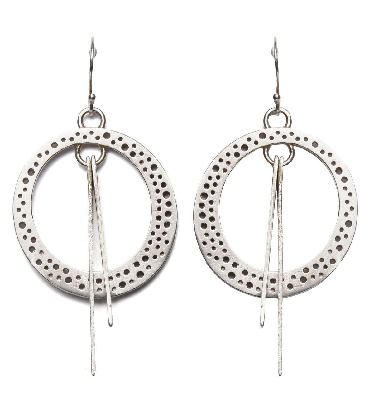 A pair of Rivera Earrings by Gallardo & Blaine Designs featuring large, circular hoops with Art Deco-inspired perforated patterns along the edges. Each hoop has two thin, elongated silver pieces hanging from the center. The earrings are suspended from sim