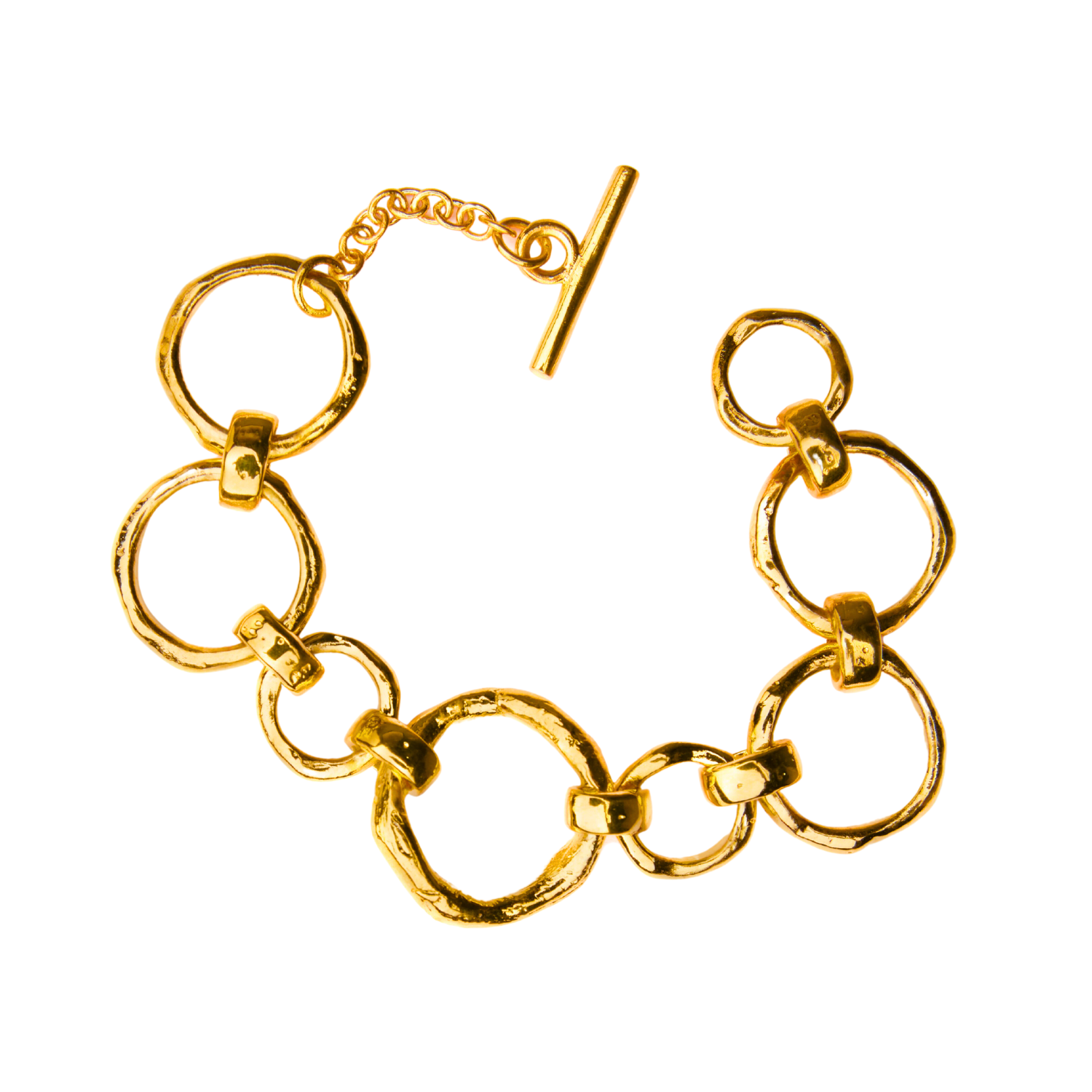 Image of the Gallardo & Blaine Designs Sea Honey Bracelet Gold Plated Bronze with round, textured links of varying sizes interconnected, featuring bronze links subtly mingled within. The bracelet, adorned with elegant gold plating and a toggle clasp closu