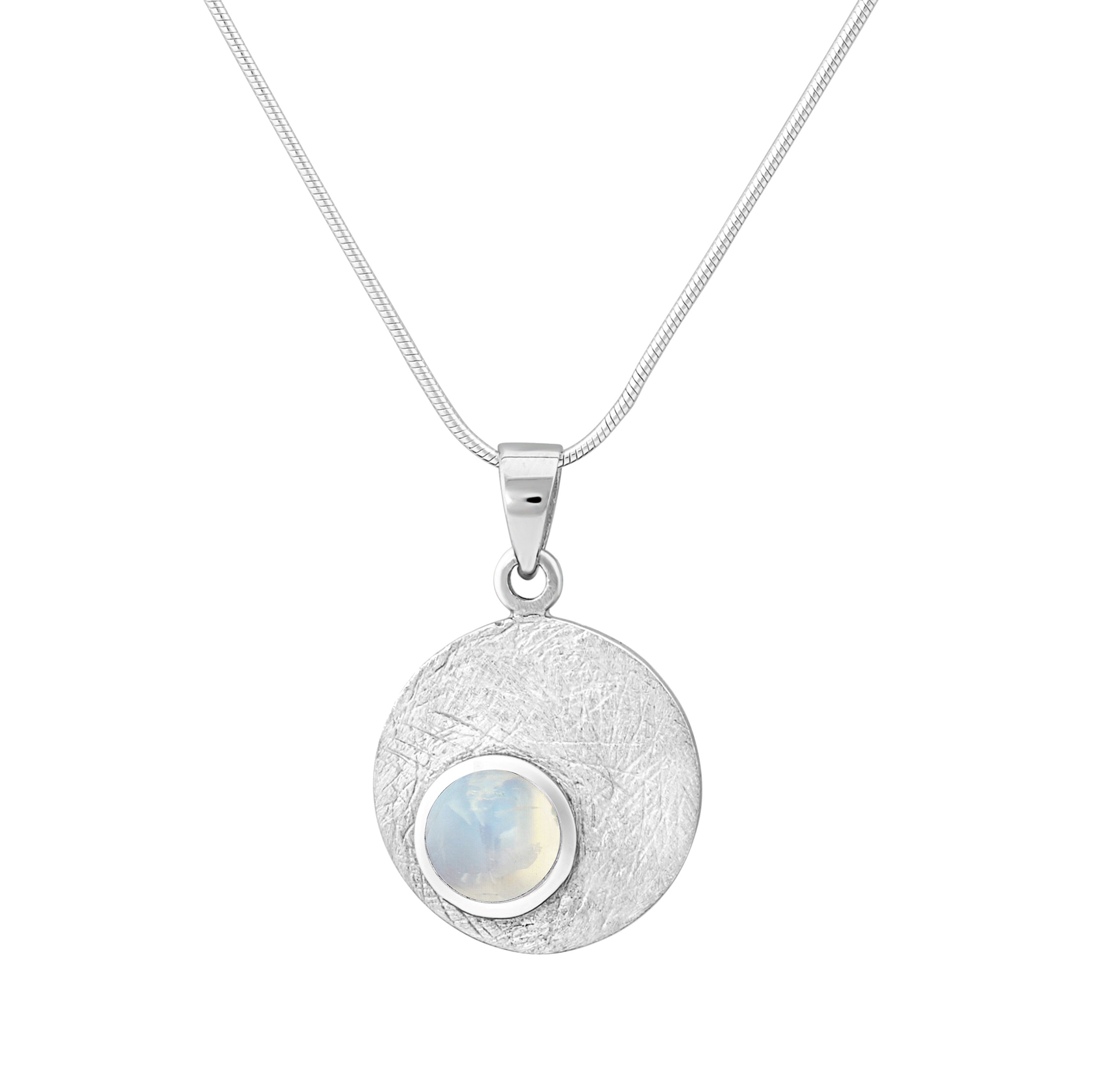 The Selene Necklace Silver - Small in various gemstones by Gallardo & Blaine Designs is a delicate piece featuring a round, textured pendant with a small moonstone at its center. The pendant is encased in a gold bezel and attached to a sleek Sterling silv