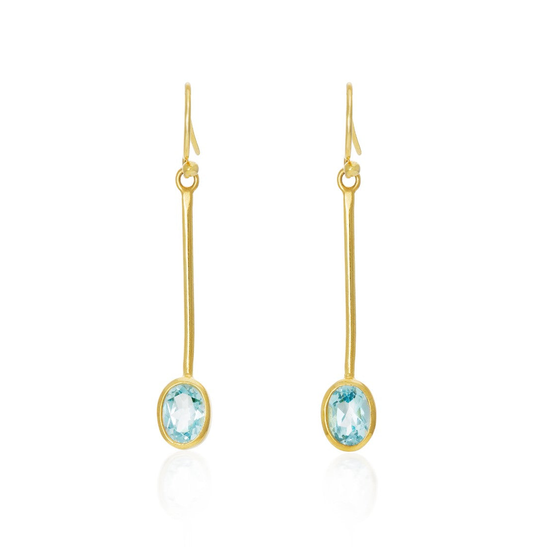 The Sequola Earrings in various gemstones by Gallardo & Blaine Designs are minimalist gold drop earrings featuring thin, elongated bars that hang vertically, each ending with an oval-cut, pale blue gemstone. These sleek and elegant dangle earrings have a