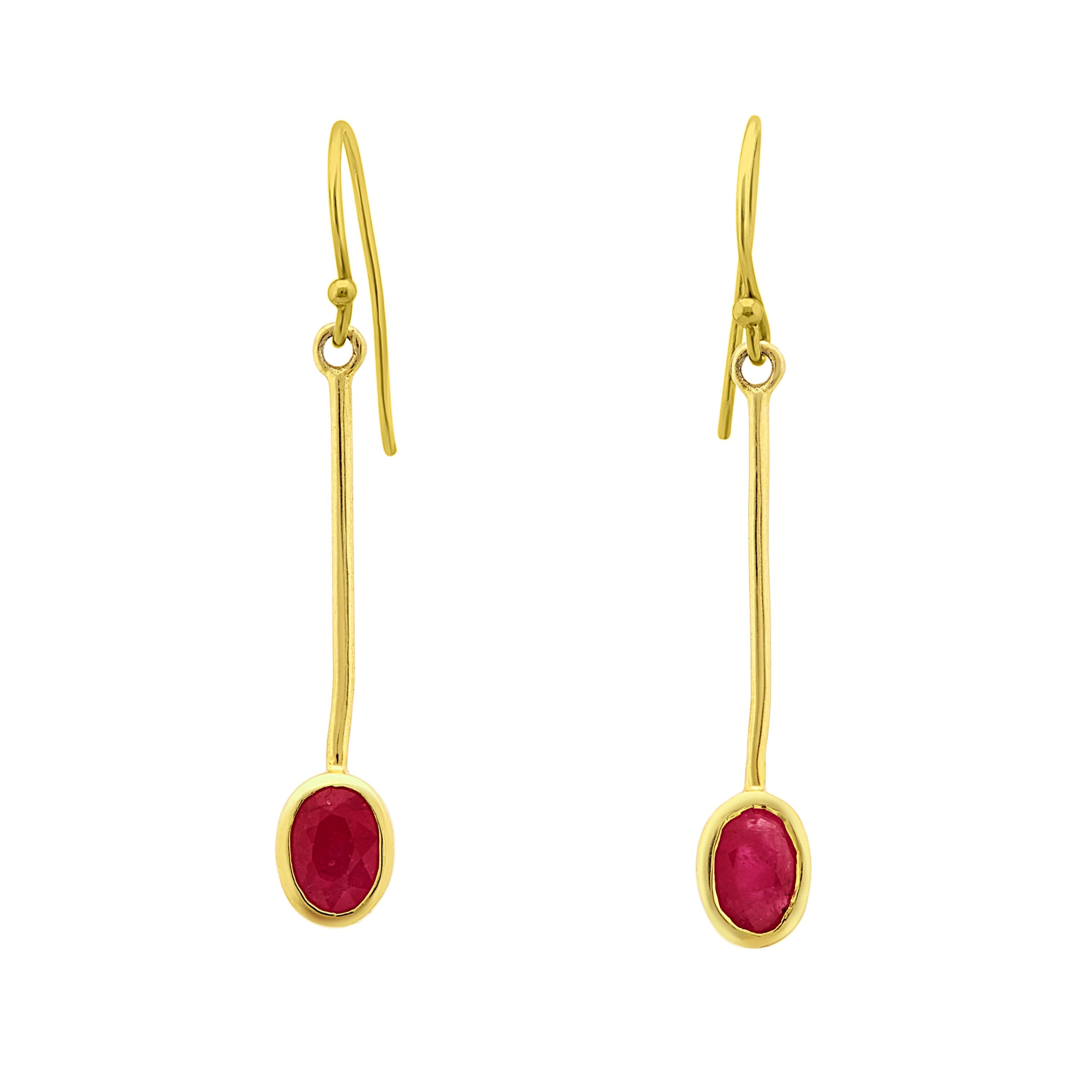 Introducing the Sequola Earrings in various gemstones from Gallardo & Blaine Designs: A pair of elegant gemstone dangle earrings featuring slender, straight gold rods with oval red gemstones at the ends. The sleek design and vibrant gemstones add a touch