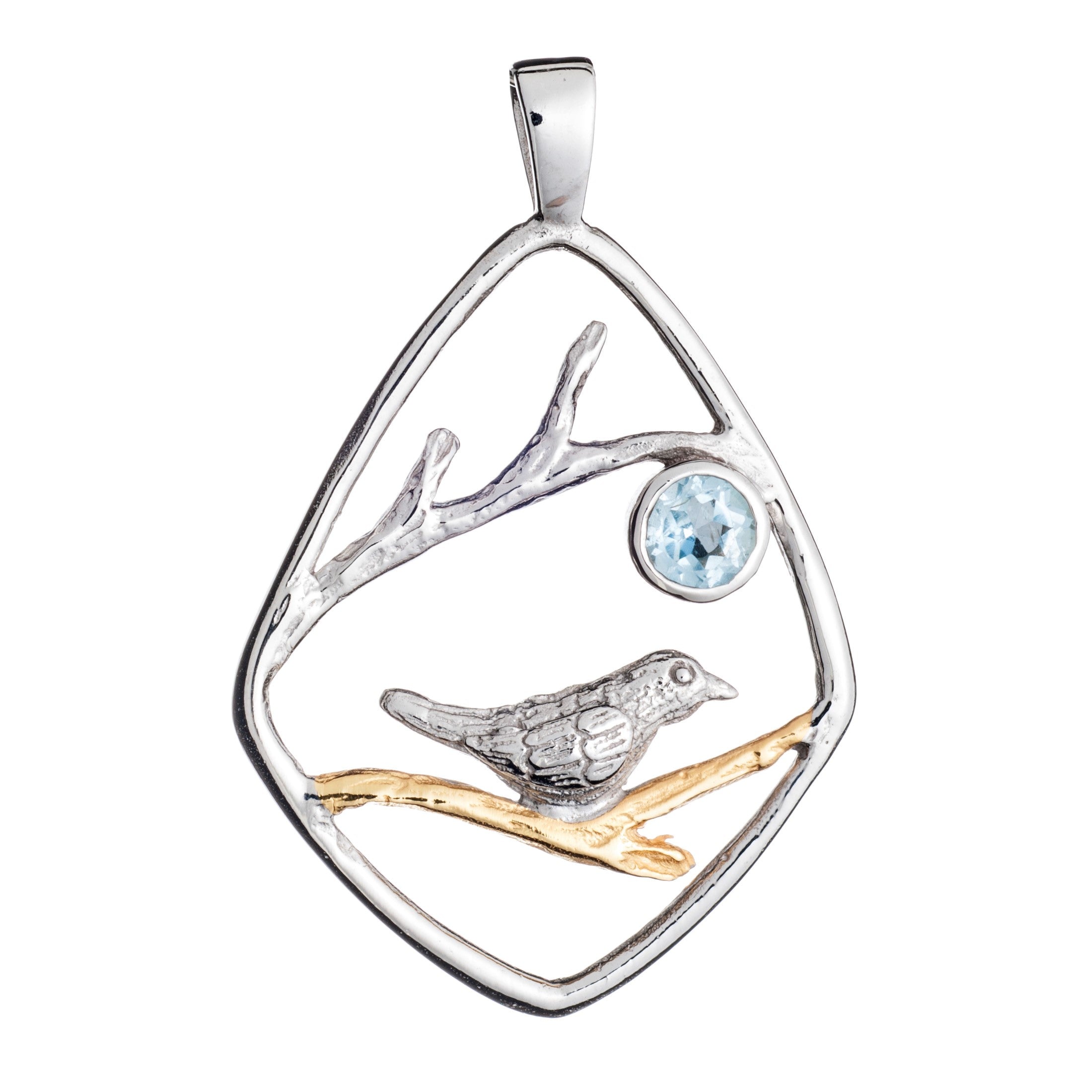 The Gallardo & Blaine Designs Song Bird Pendant features a mixed metal design of a song bird perched on a branch. The bird and branch are encased in a diamond-shaped sterling silver frame. A light blue gemstone adds a touch of color above the bird. The pe