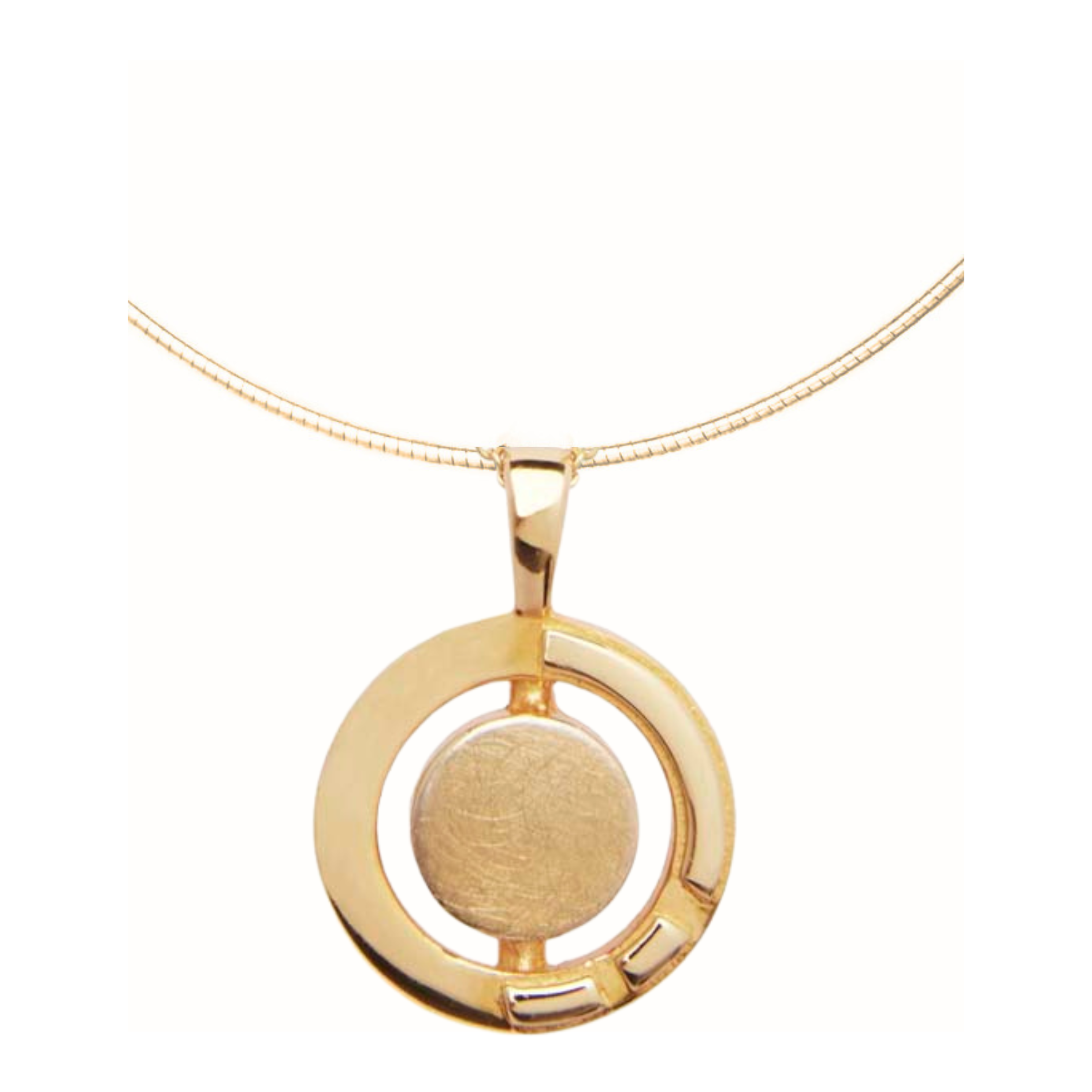 A gold vermeil necklace featuring a circular pendant. The pendant has a solid central circle enclosed within an open circular frame with a small rectangular cutout in the bottom right quadrant. Inspired by Irish heritage jewelry, the Urú Large Pendant &