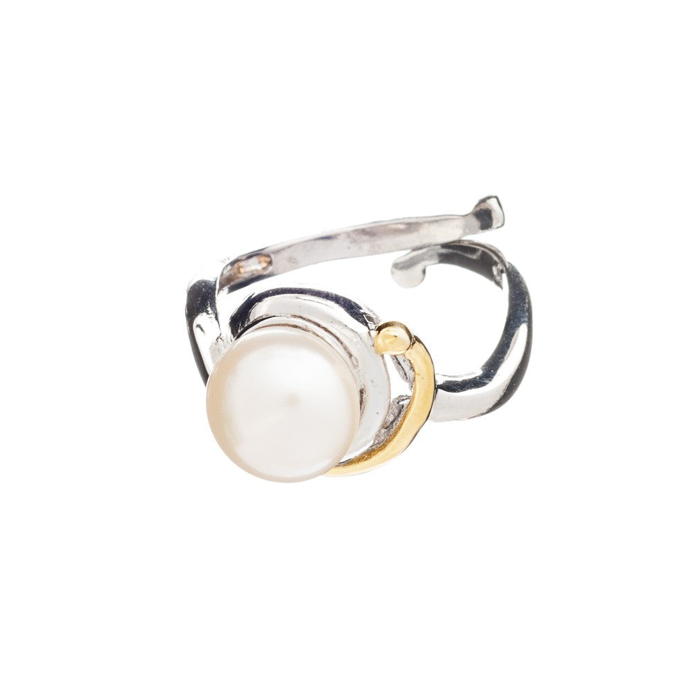 The Wave Ring by Gallardo & Blaine Designs is a silver open band ring featuring a large centrally set white pearl, with a thin gold accent forming a partial halo around the pearl. This adjustable silver ring has a modern, irregular design, combining elega