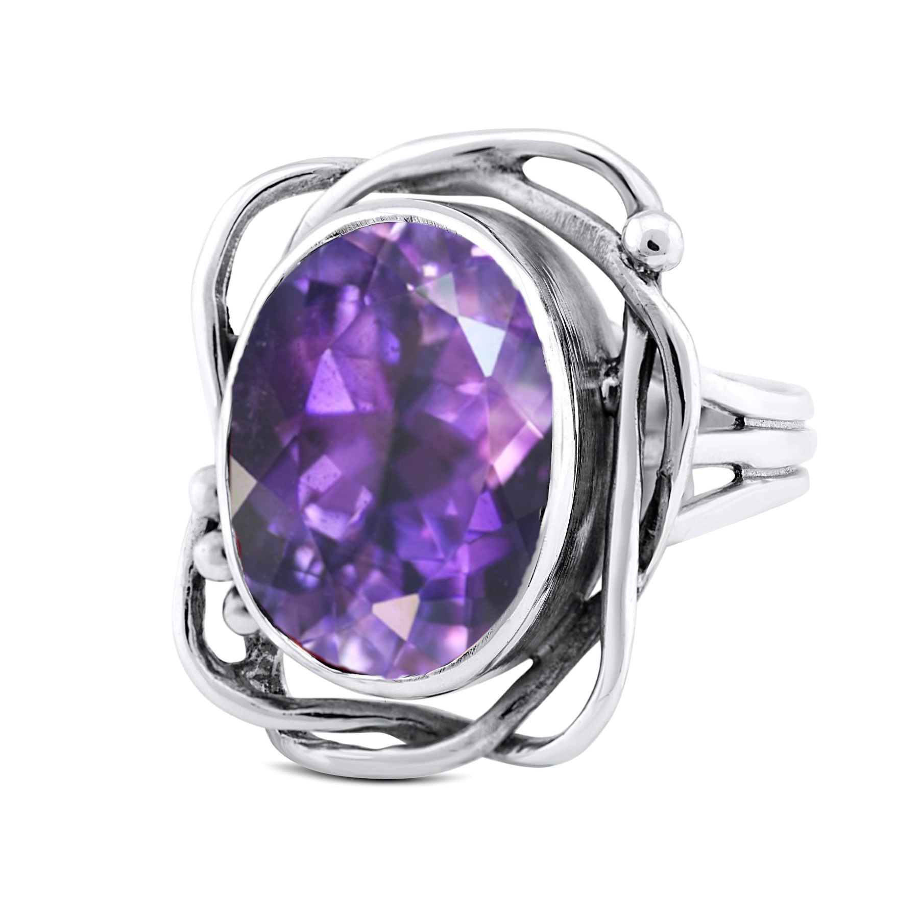 An Arthurian silver ring featuring an ornate design with an intricate, swirled band. The centerpiece is a large, faceted purple gemstone, possibly an amethyst, set in an elegant and artistic setting. This vintage, handcrafted Whirlpool Ring in various gem