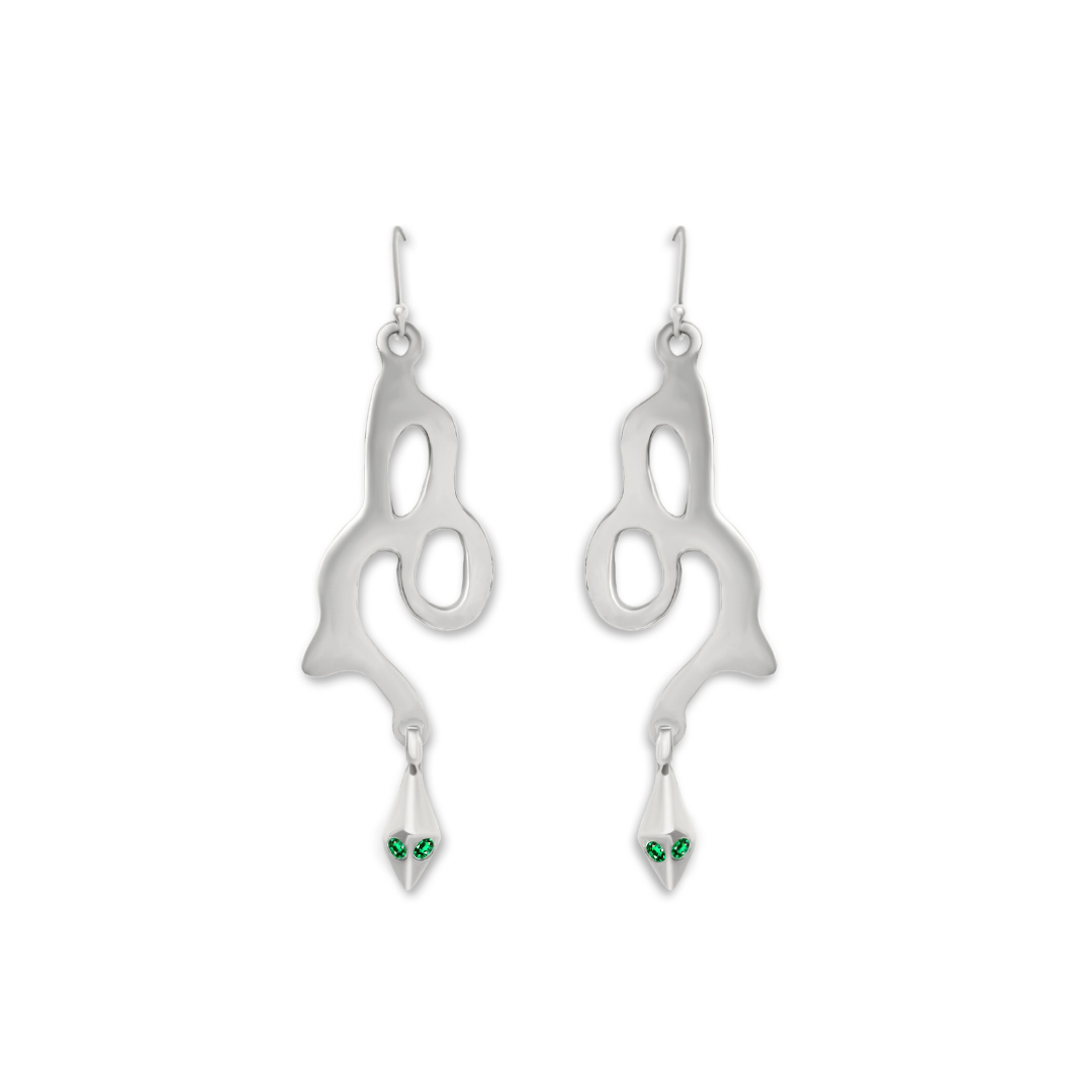 Introducing the Serpent Earrings by Madeleine Blaine—a stunning pair of handmade silver dangle earrings with abstract, wavy silhouettes and drop accents reminiscent of snakeheads, exquisitely adorned with small green gemstones for eyes.