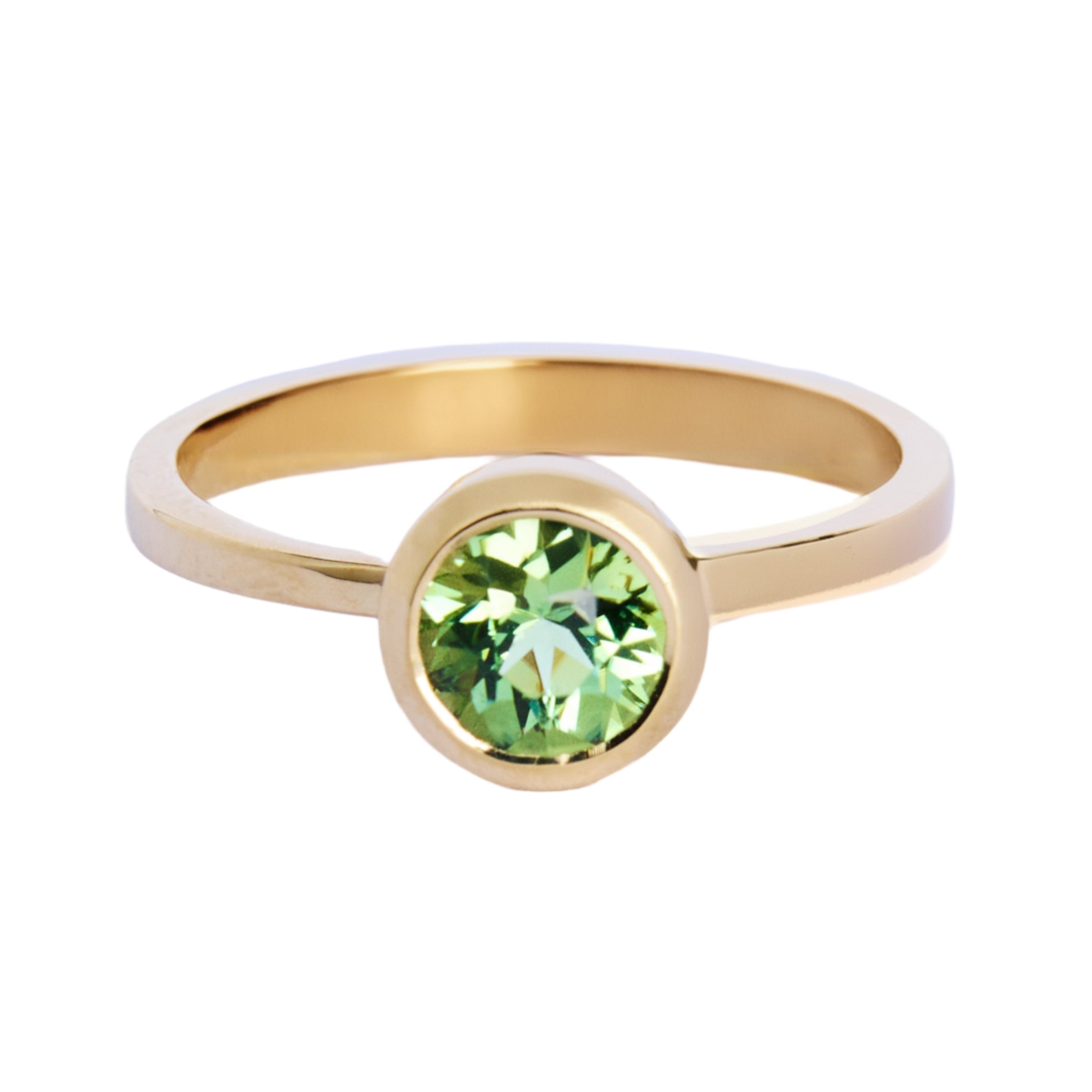 The Viridian Dawn 9ct yellow gold ring by Madeleine Fine Jewellery showcases a round green gemstone in a sleek bezel setting—ideal as a green Beryl or stacking ring, shown on a white background.