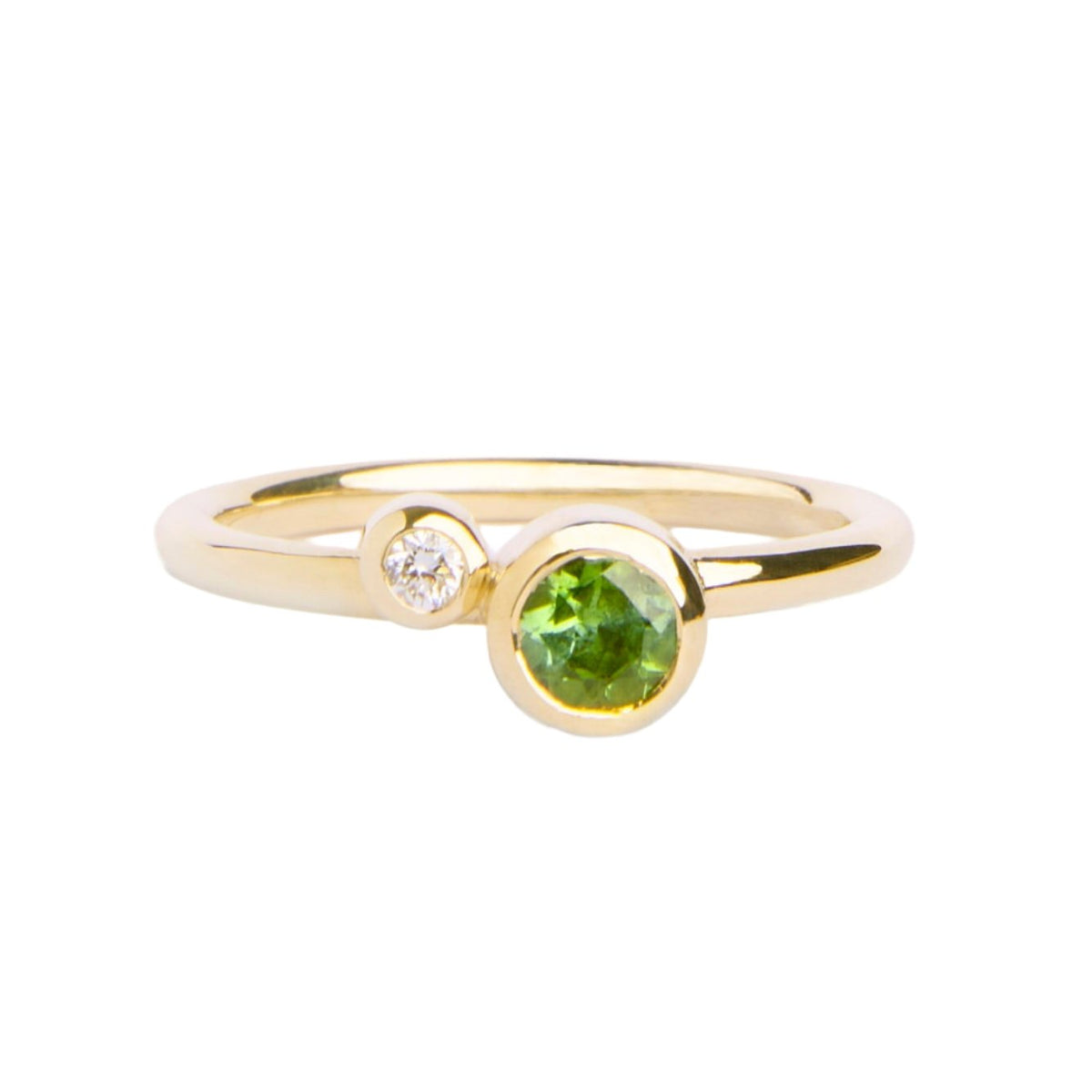 The Willow Shimmer 9ct yellow gold ring from Madeleine Fine Jewellery features a round green tourmaline and a sparkling diamond set side by side on a slim band.