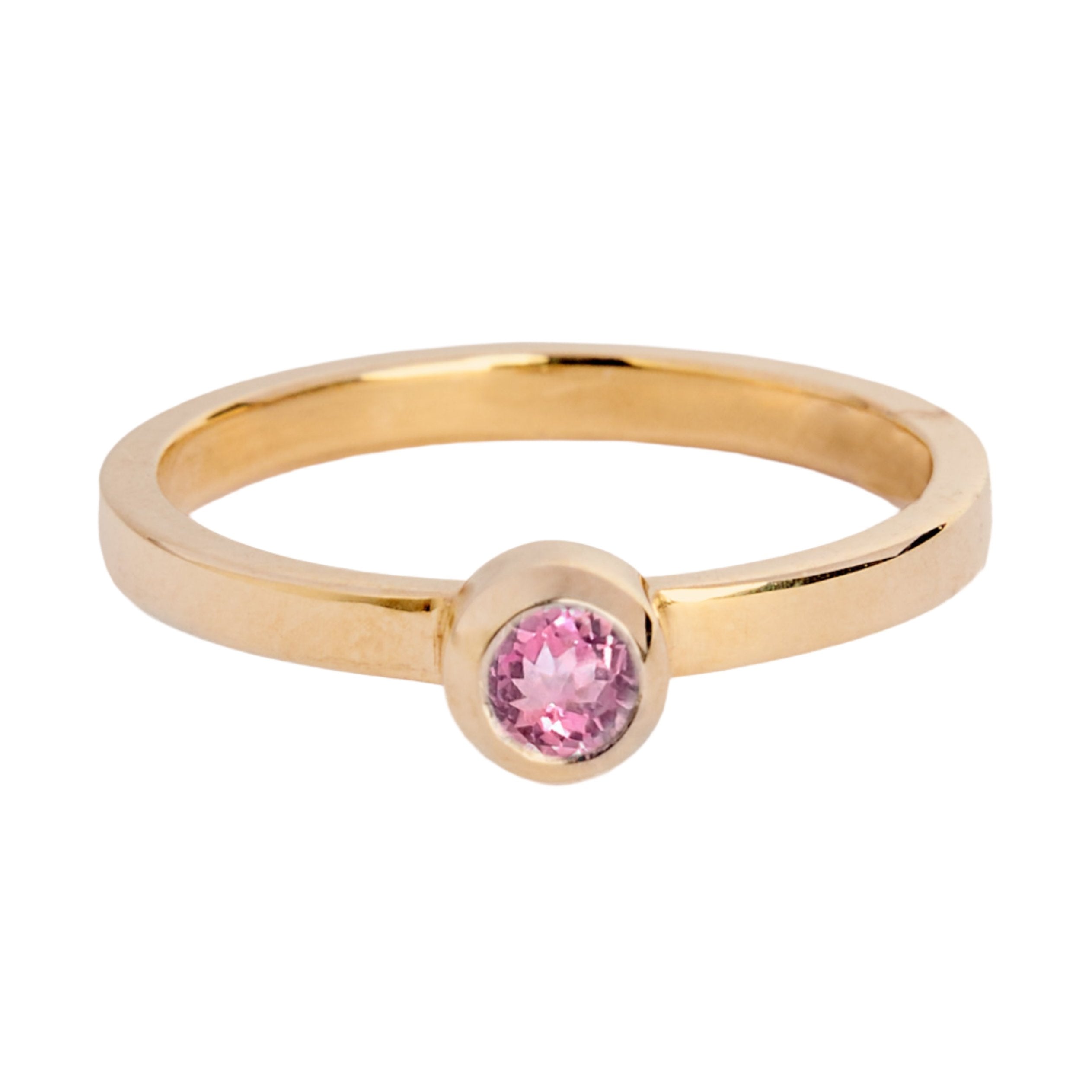 The Gilded Blossom 9ct yellow gold ring by Madeleine Fine Jewellery features a round pink gemstone in a bezel setting, shown on a white background.