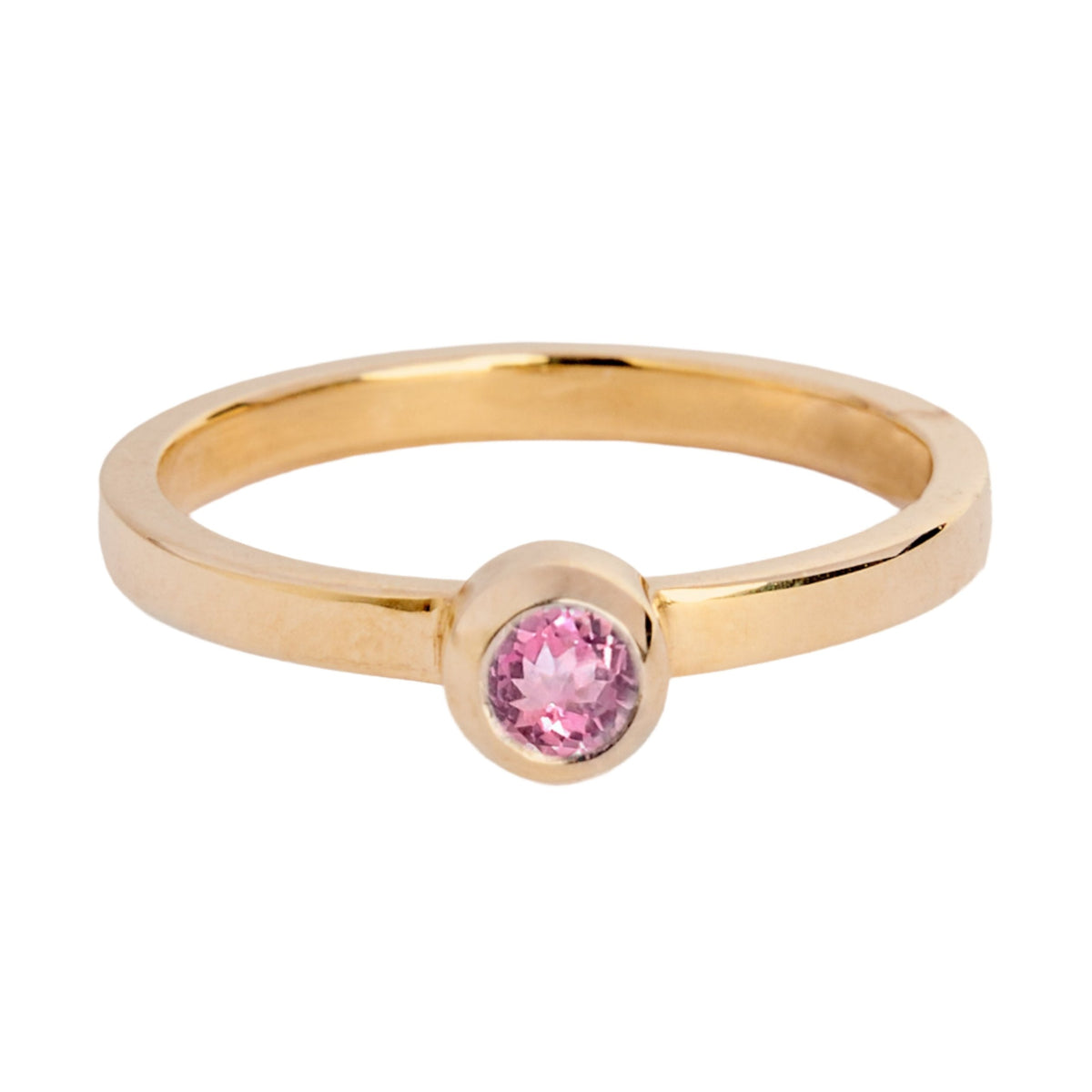 The Gilded Blossom 9ct yellow gold ring by Madeleine Fine Jewellery features a round pink gemstone in a bezel setting, shown on a white background.