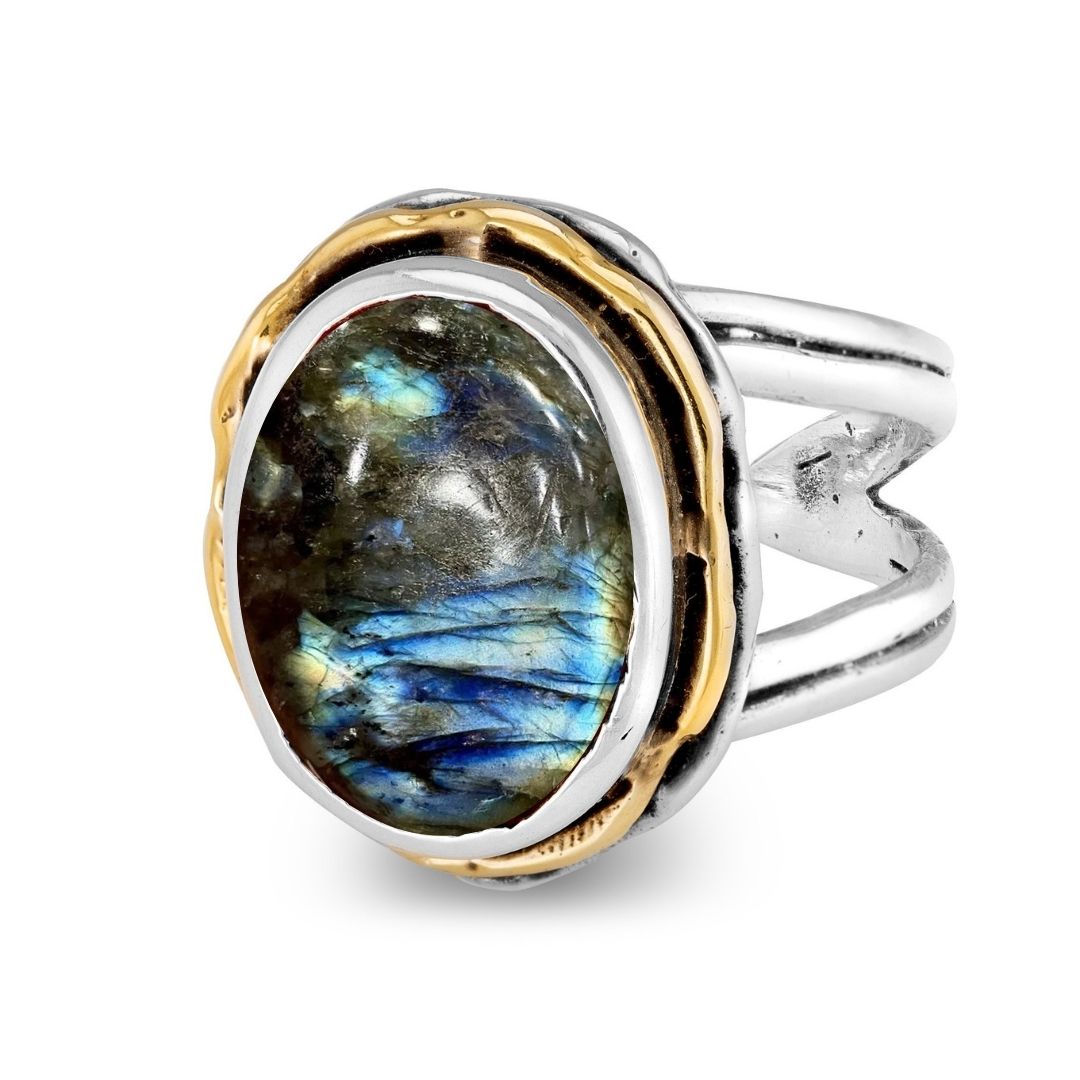 The Magnolia Ring by Gallardo & Blaine Designs features sterling silver, gold accents, and a striking oval labradorite gemstone with blue-green iridescence in a mixed metal bezel.