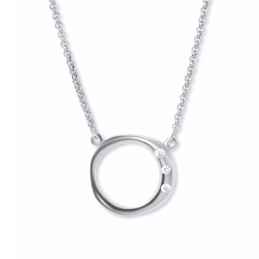 Introducing the Cualli Necklace by Gallardo & Blaine Designs—a sterling silver pendant necklace showcasing a minimalist open circle adorned with three sparkling cubic zirconia stones on one side. The delicate chain attaches at both sides of the circular p