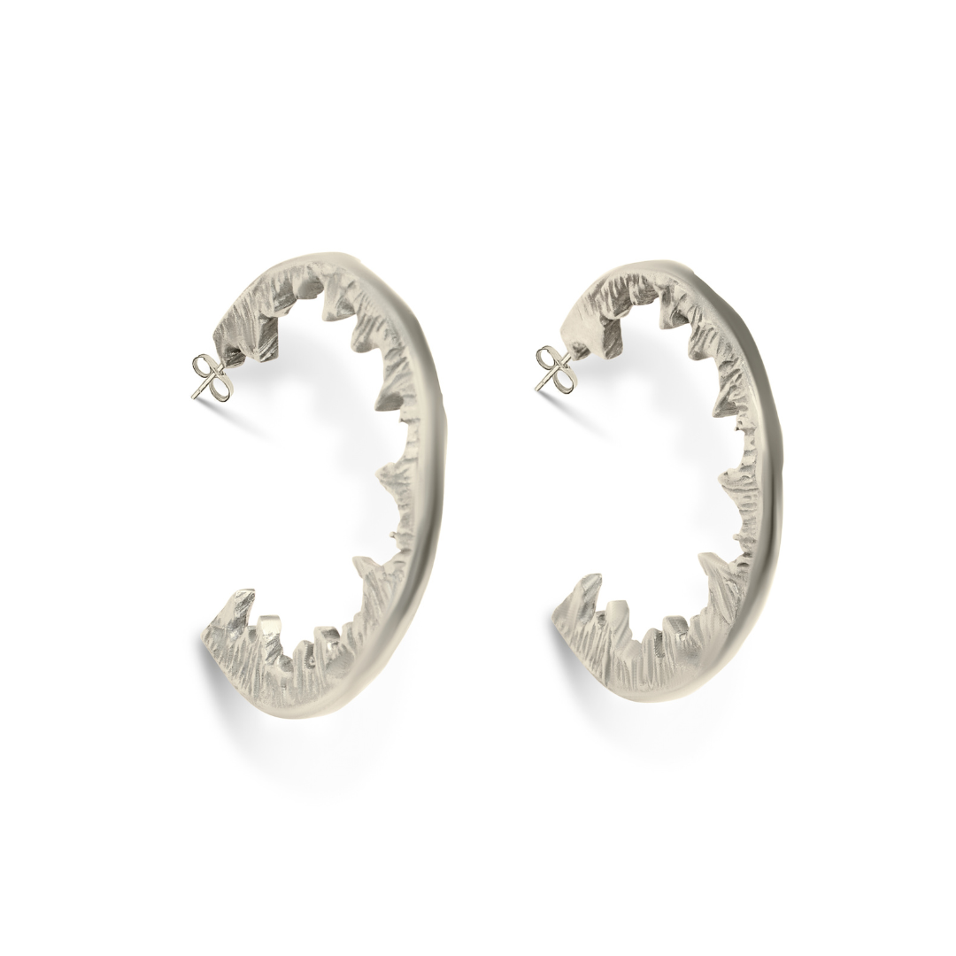 Elements Hoops by Madeleine Sculptural Jewellery: bold silver statement earrings shaped like open shark jaws with detailed teeth, perfect for those who dare to stand out. Displayed on a white background.