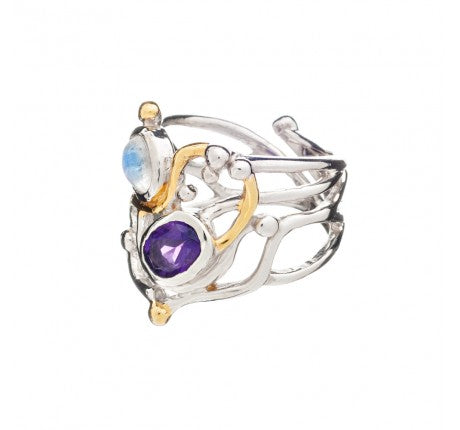 A unique, intricate Seaweed Ring in various gemstones made of sterling silver with gold vermeil accents by Gallardo & Blaine Designs. It features two gemstones: a blue one on top and a purple one below, set within an elaborate design of intertwining metal