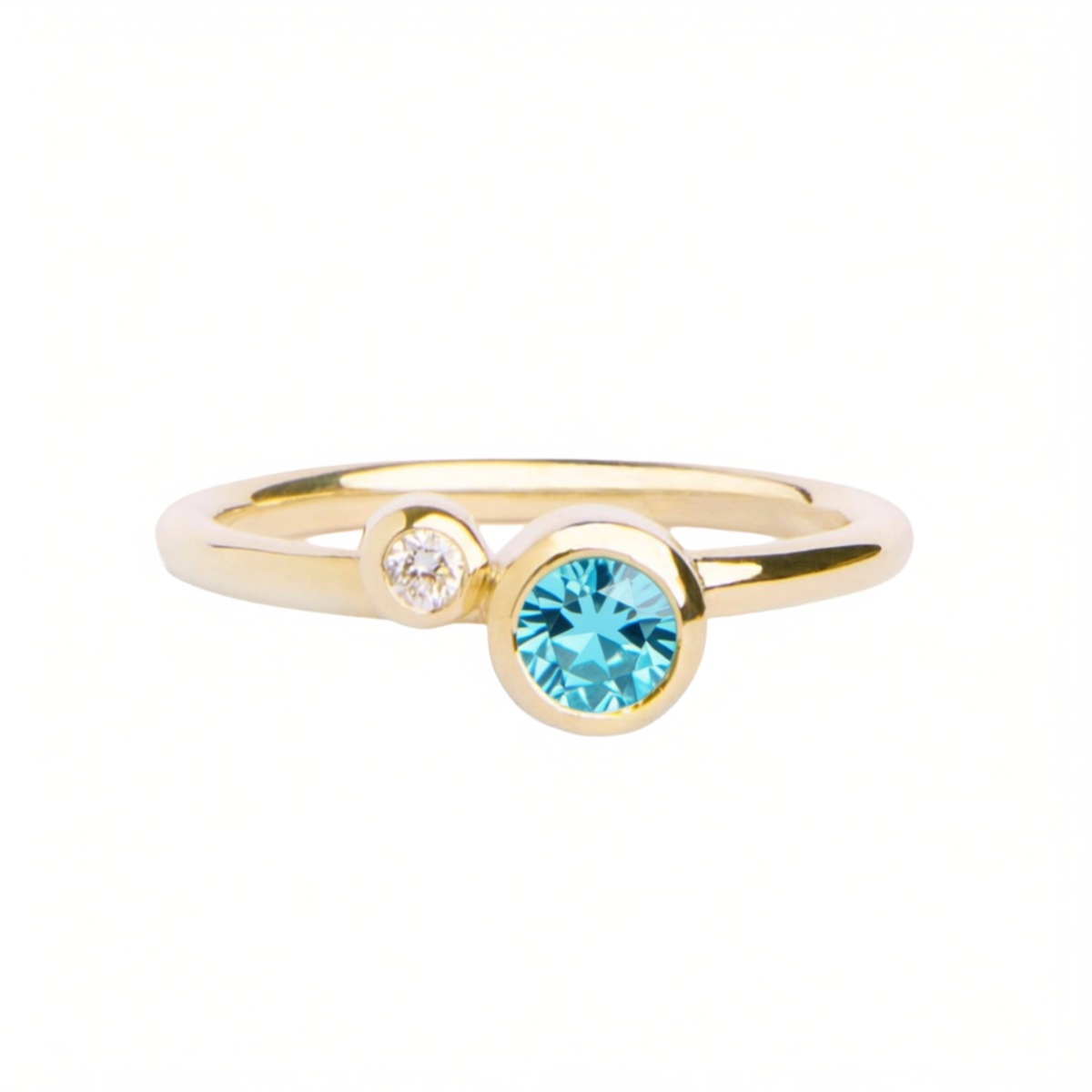 Introducing the Sky Blue Shimmer 9ct yellow gold ring by Madeleine Fine Jewellery—a nature-inspired piece featuring a dazzling round blue topaz paired with a delicate clear gemstone, both set side by side on a sleek 9ct yellow gold band.
