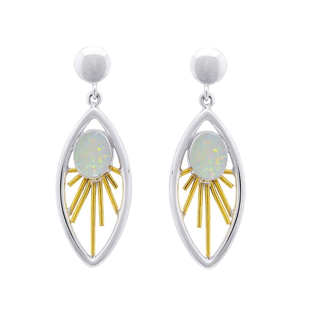 Gallardo & Blaine Designs’ Goddess Earrings showcase an oval gemstone center with gold sunburst rays in a marquise frame, finished with silver studs—a striking accessory for any occasion. Available in various gemstones.