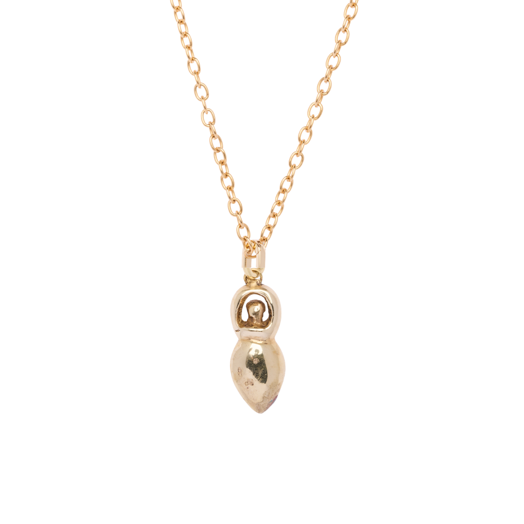 A gold chain necklace featuring the Danu Pendant by Madeleine Sculptural Jewellery, designed as a small, stylized abstract human figure with a rounded head and teardrop-shaped body.