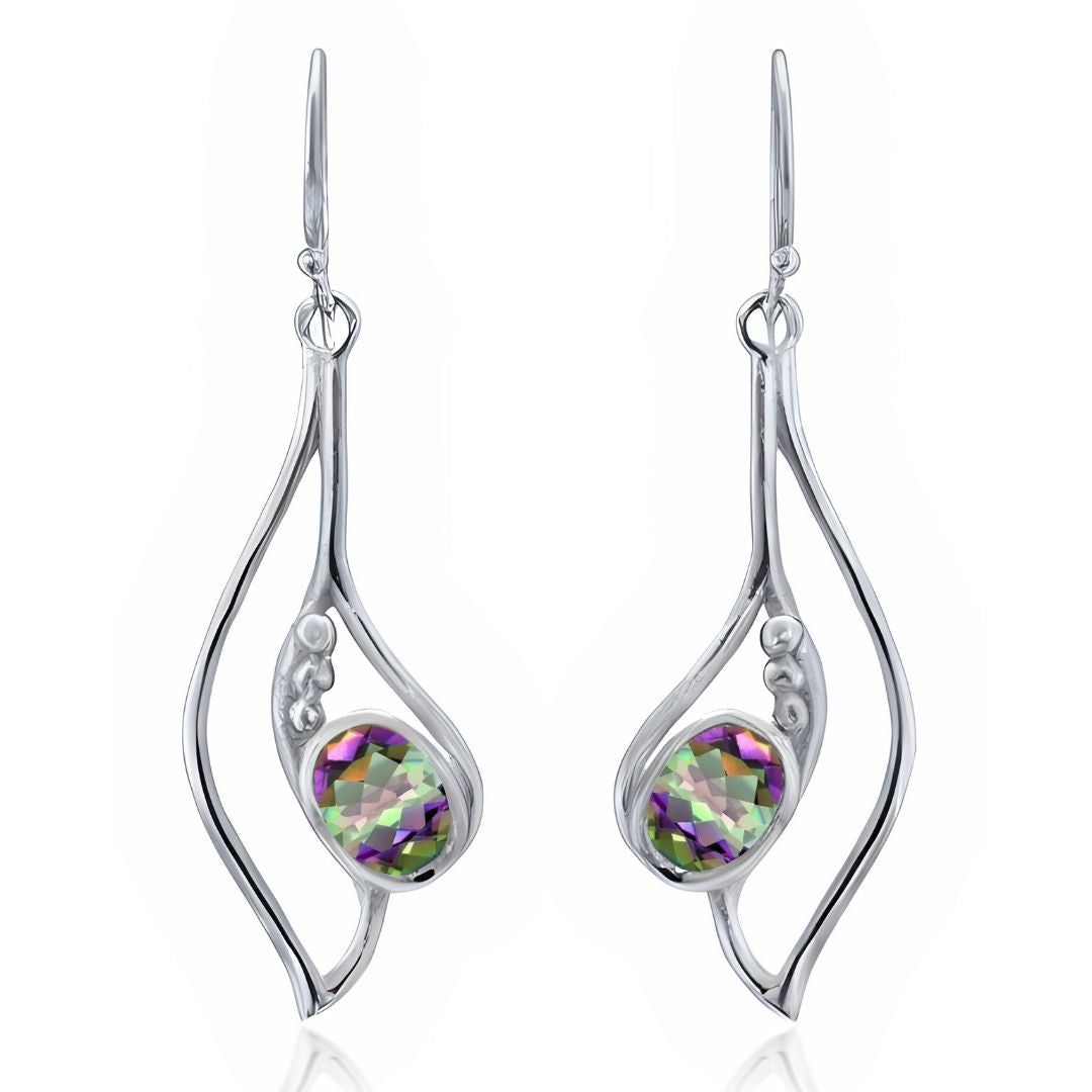 Add shine to your style with the Iris Earrings in various gemstones by Gallardo & Blaine Designs—dangle earrings featuring abstract silver frames and faceted oval stones in green, purple, and clear hues.