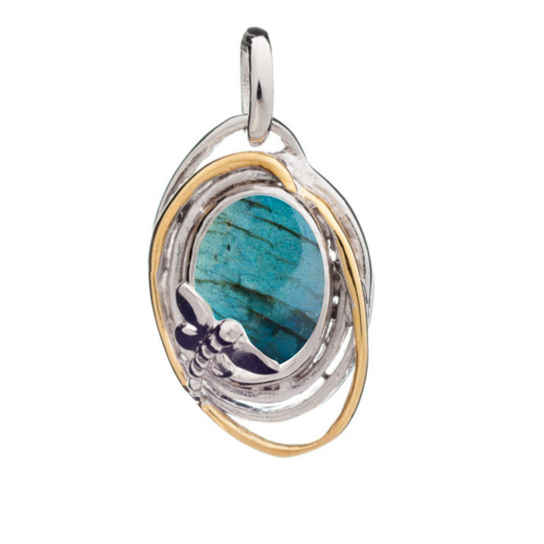 The Lagoon Pendant Small by Gallardo & Blaine Designs features a gemstone encircled by silver and gold rings, accented with a delicate dragonfly design at the base. Available in various gemstones.