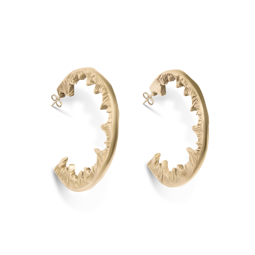 Elements Hoops by Madeleine Sculptural Jewellery are gold statement earrings shaped like open jaws with pointed teeth—bold, handmade pieces ideal for standout jewellery lovers. Displayed against a white background.