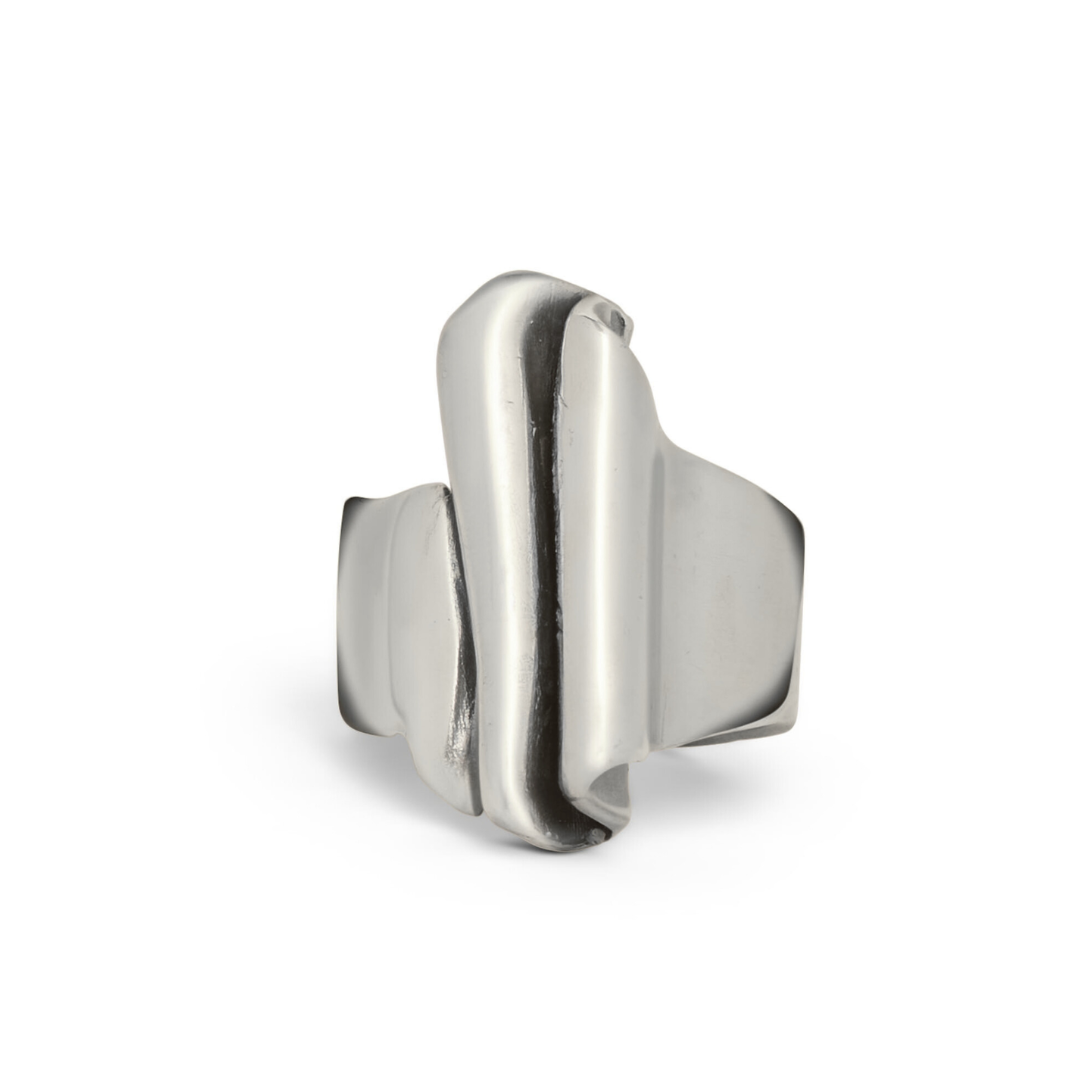 The Tonnach Ring Large by Madeleine Sculptural Jewellery features a modern, abstract design with smooth, asymmetrical folds and curves, embodying sustainable elegance against a white background.