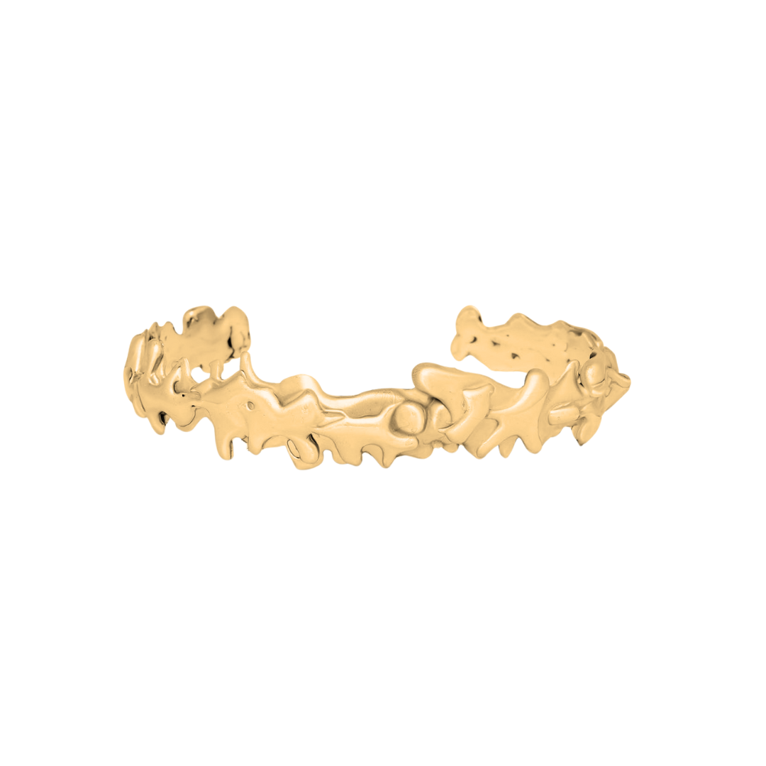 The Molten Cuff Small by Madeleine Blaine is a gold bracelet with an open design and an irregular, organic texture reminiscent of flowing shapes, displayed against a plain white background.