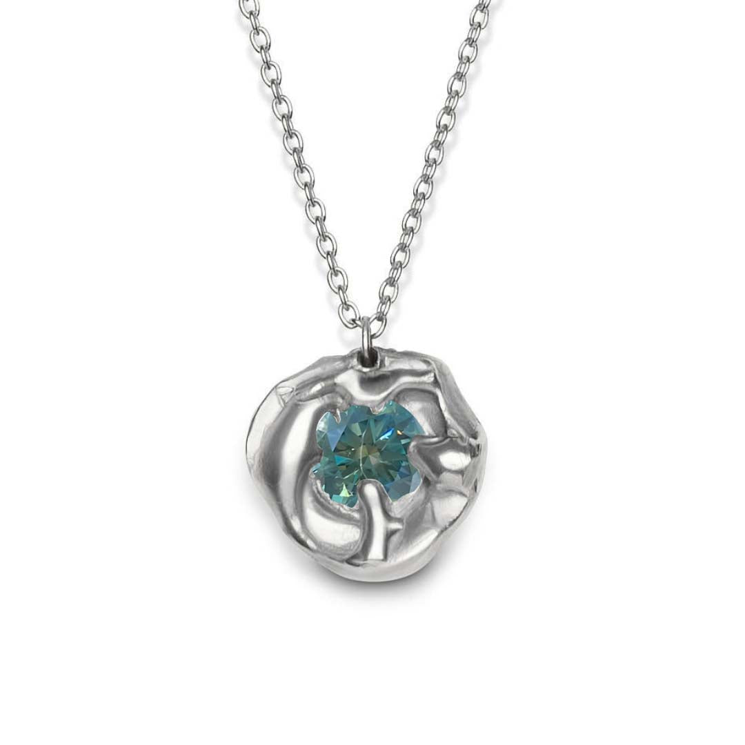 The Molten Necklace with Moissanite by Madeleine Sculptural Jewellery is a handmade piece featuring a silver pendant with an abstract flower design and a central round moissanite gemstone.